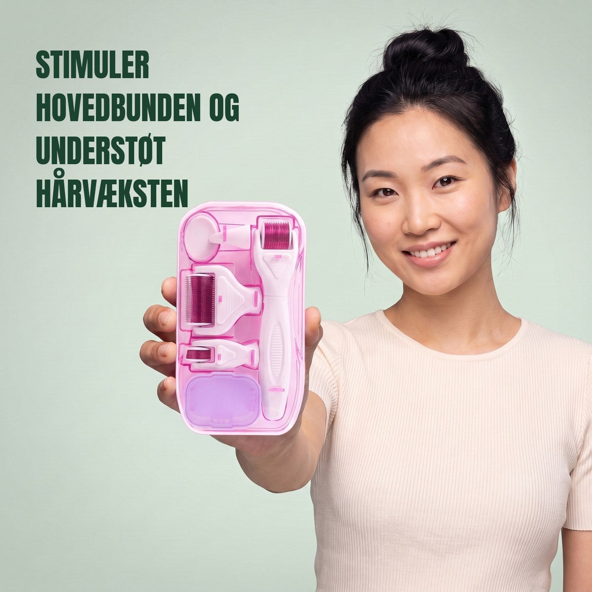 Woman holding the pink 6-in-1 dermaroller kit against a green background