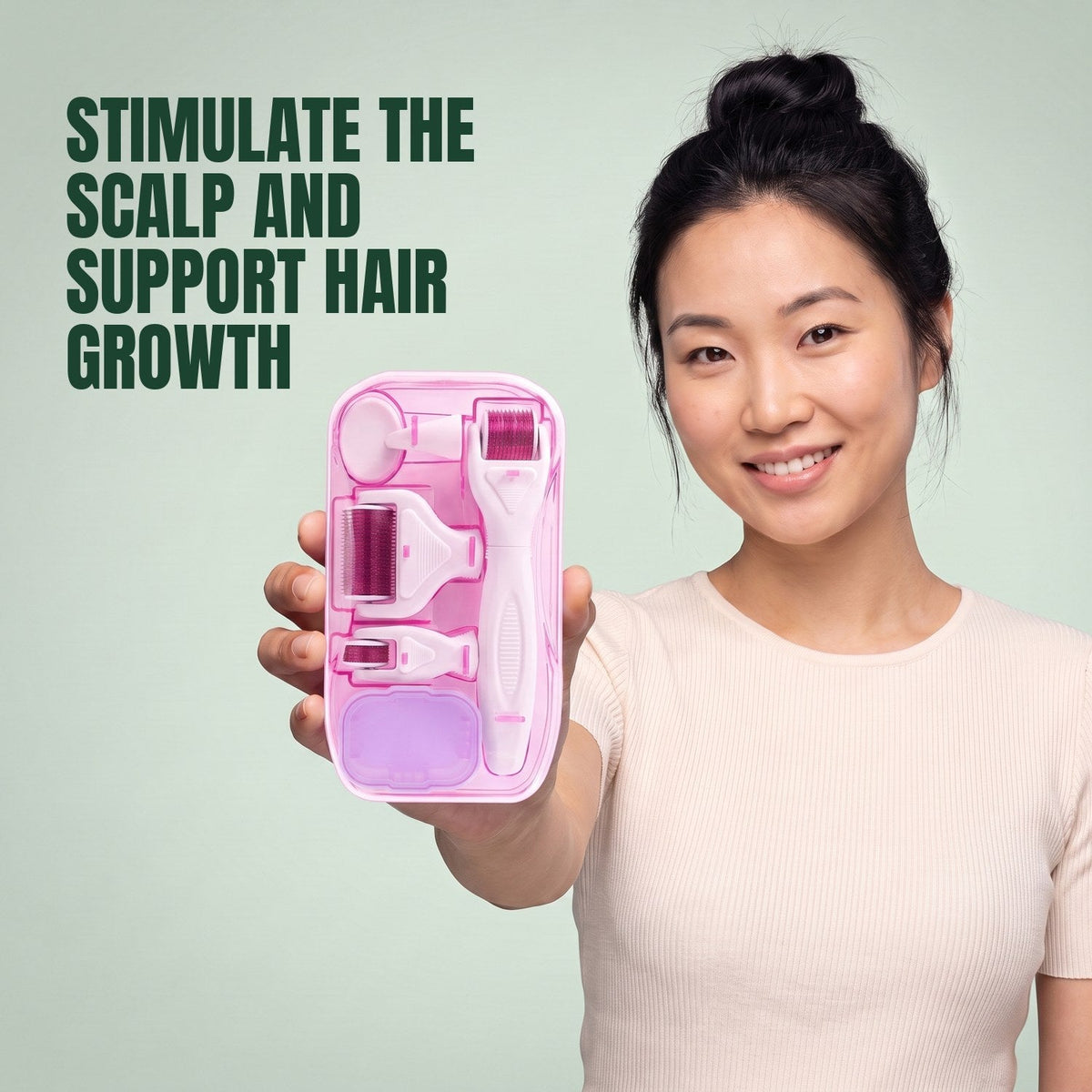 Woman holding the pink 6-in-1 dermaroller kit against a green background