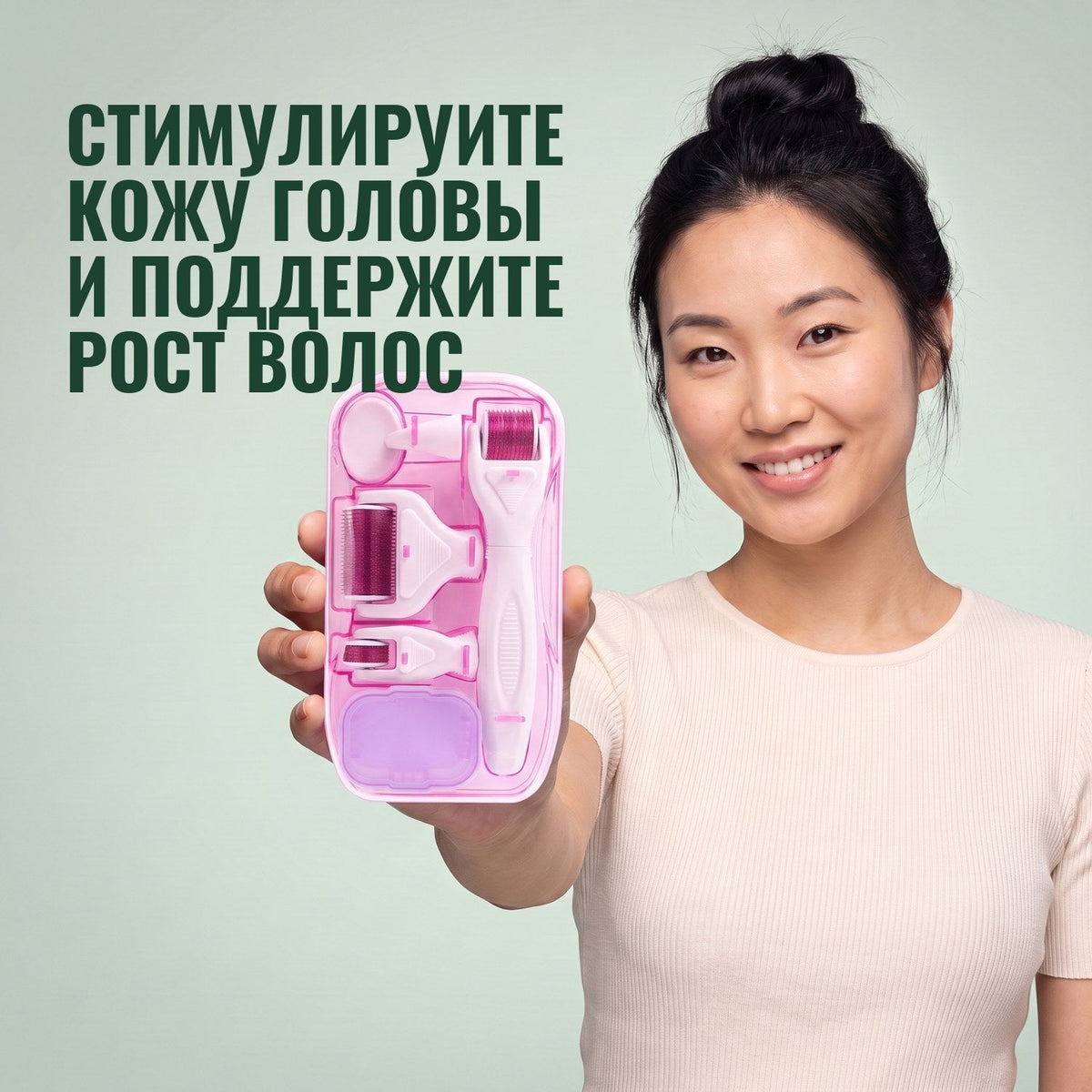 Woman holding the pink 6-in-1 dermaroller kit against a green background