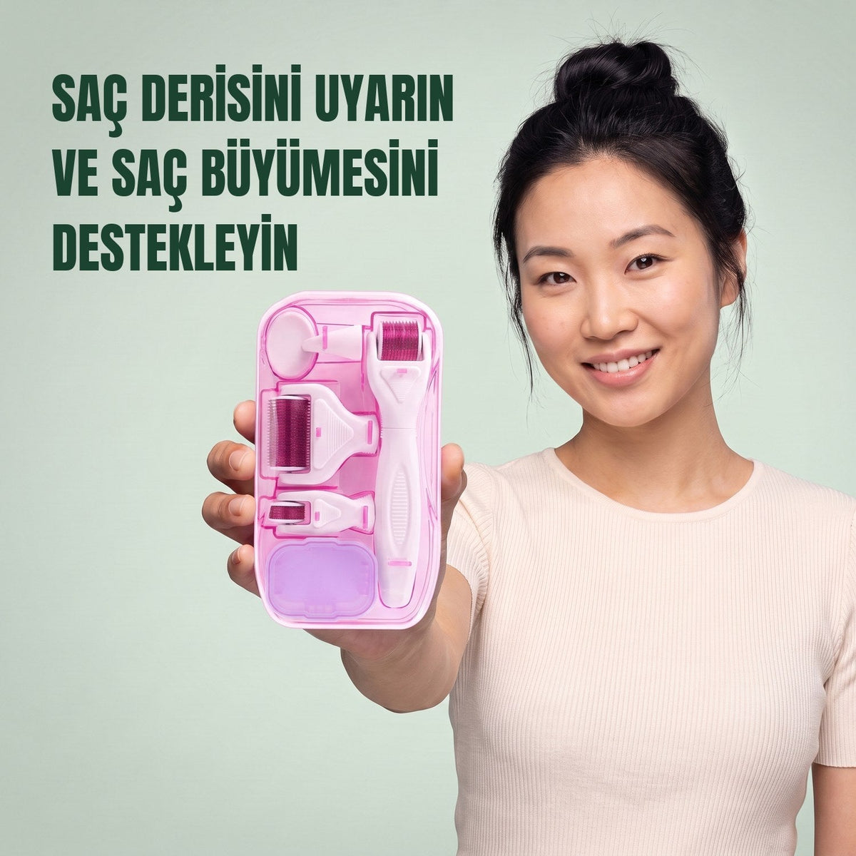 Woman holding the pink 6-in-1 dermaroller kit against a green background