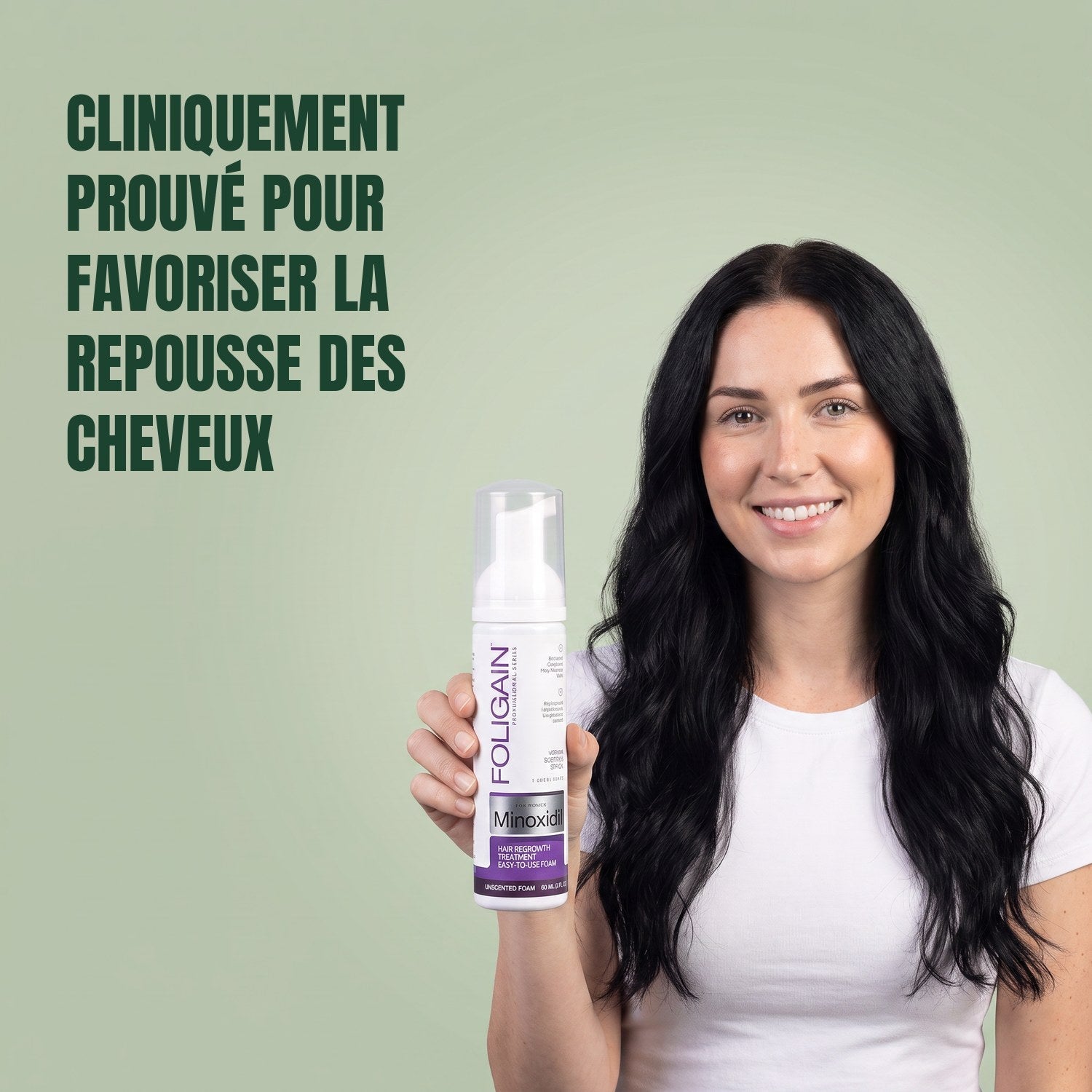 Woman holding the Foligain Minoxidil 2% foam can for women against a green background
