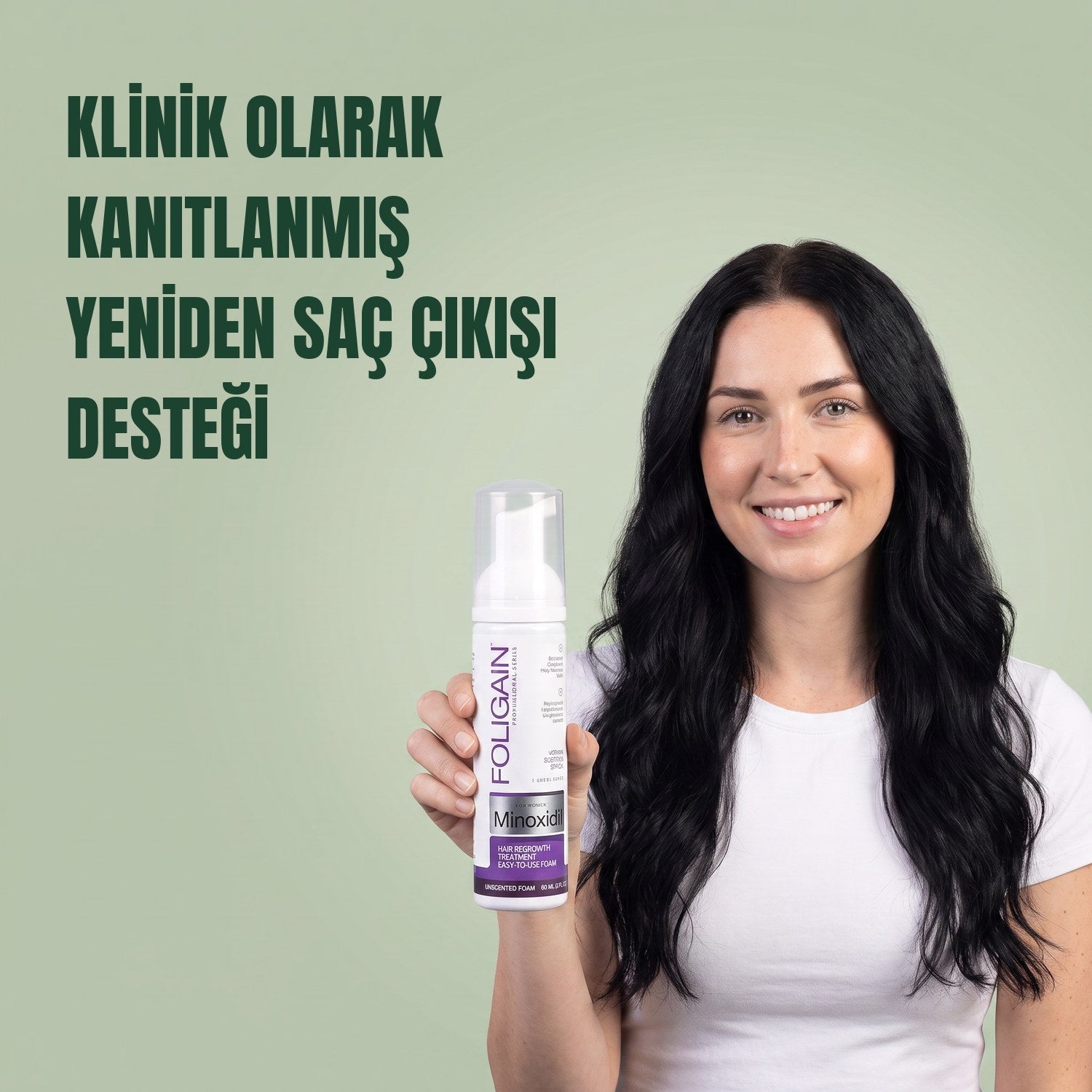 Woman holding the Foligain Minoxidil 2% foam can for women against a green background
