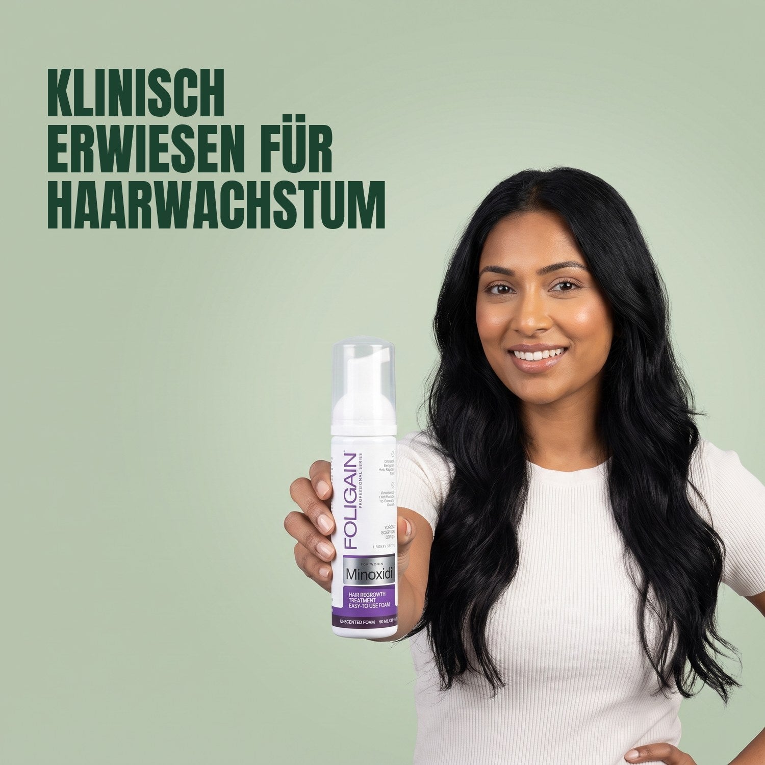 Woman holding Foligain Minoxidil 2% foam for women against a green background