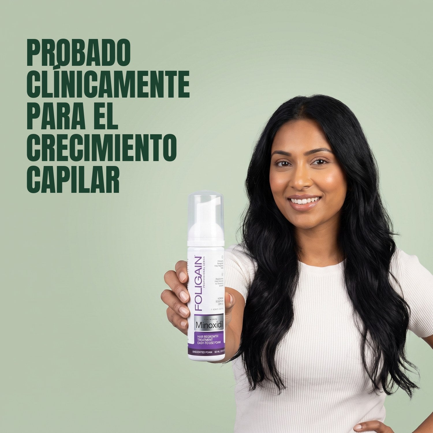 Woman holding Foligain Minoxidil 2% foam for women against a green background