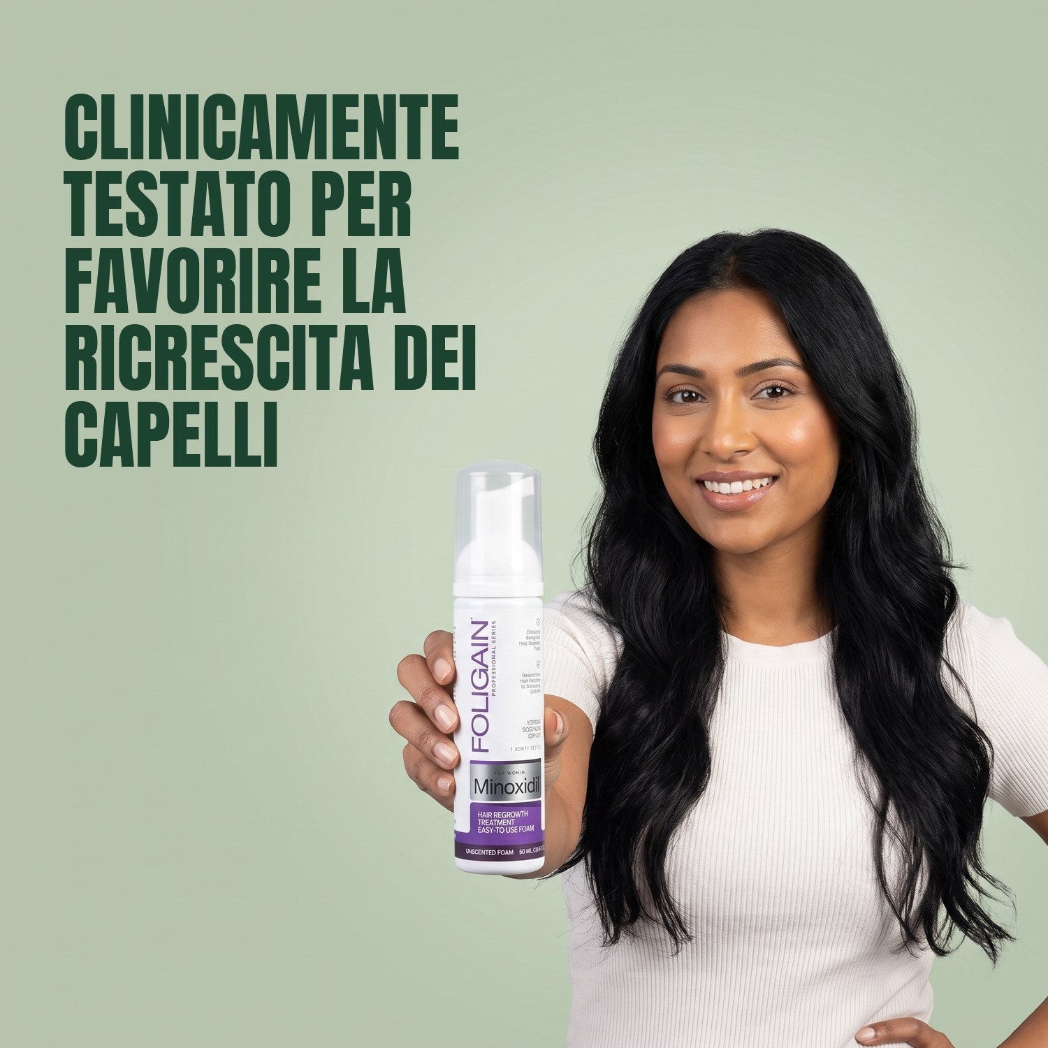 Woman holding Foligain Minoxidil 2% foam for women against a green background