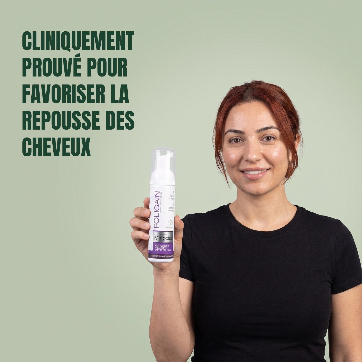 Woman holding the Foligain Minoxidil 2% foam can for women against a green background
