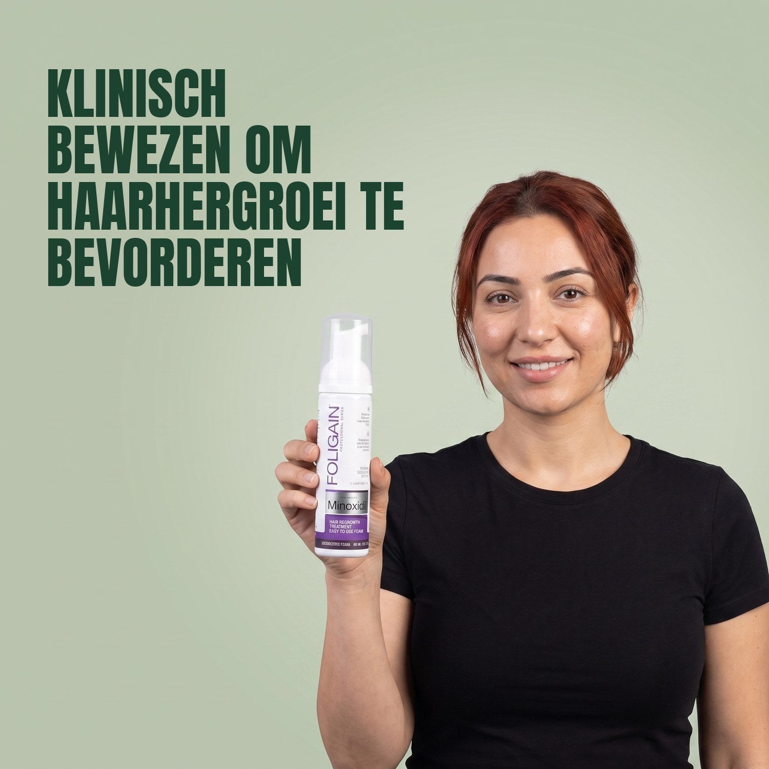 Woman holding the Foligain Minoxidil 2% foam can for women against a green background