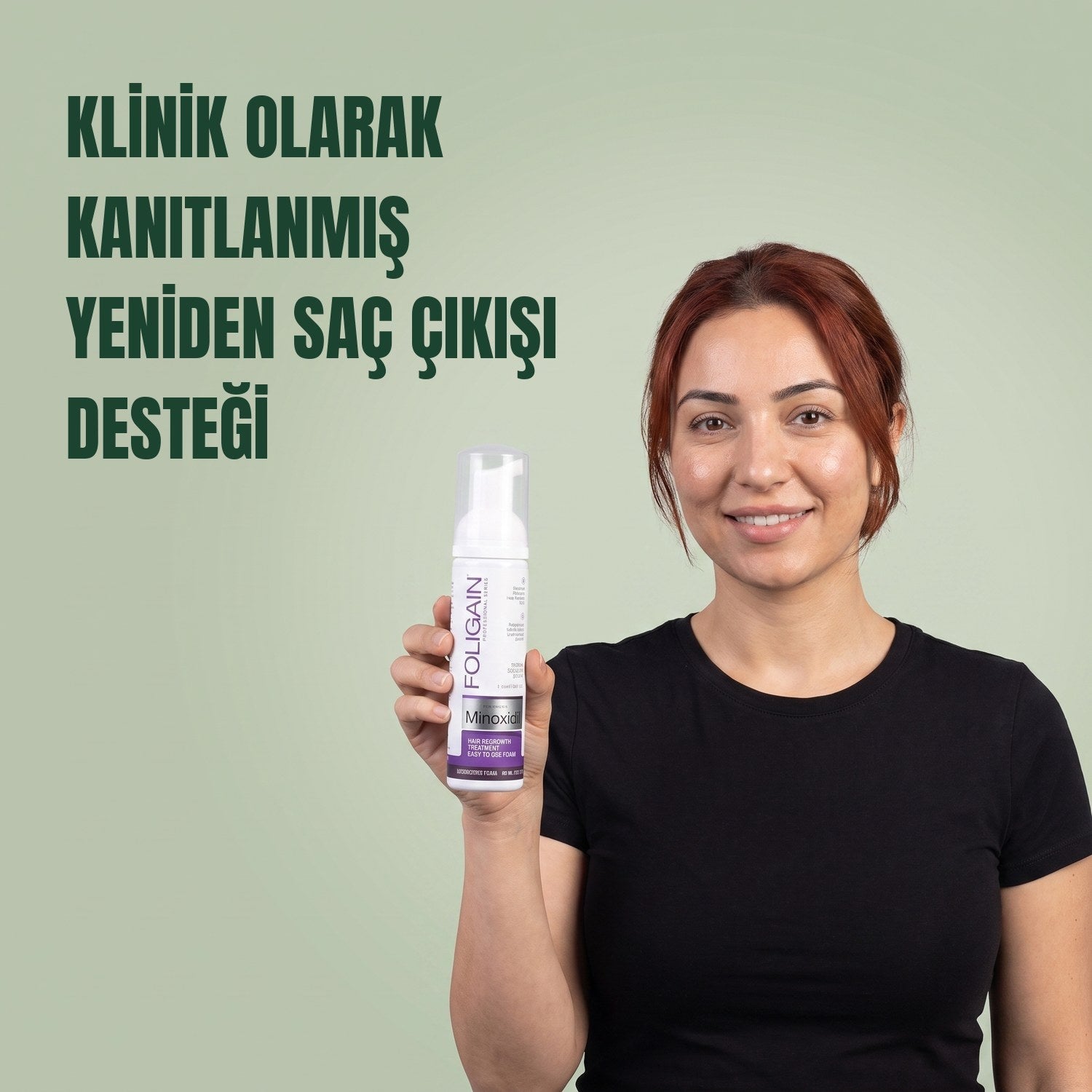 Woman holding the Foligain Minoxidil 2% foam can for women against a green background