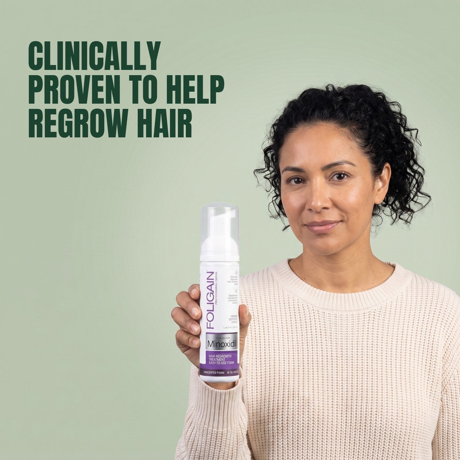Woman holding the Foligain Minoxidil 2% foam can for women against a green background