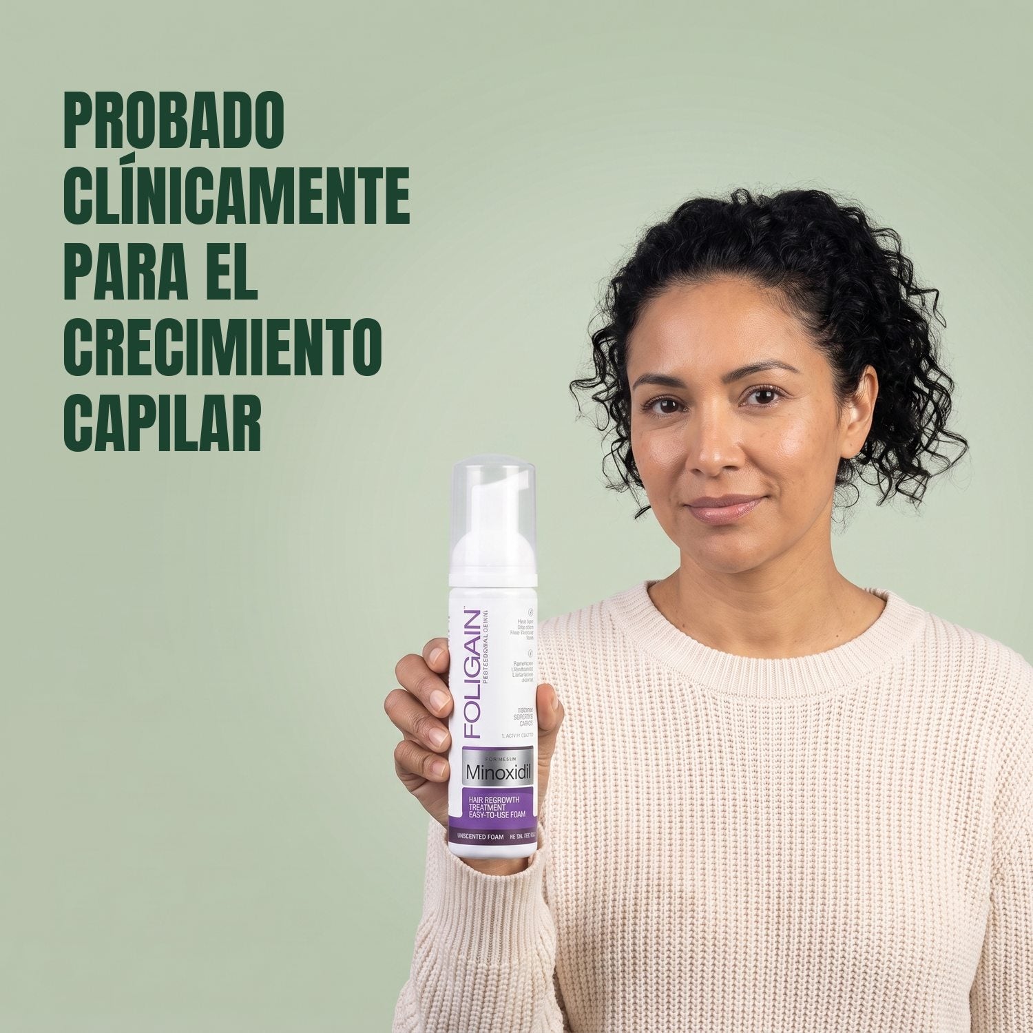 Woman holding the Foligain Minoxidil 2% foam can for women against a green background