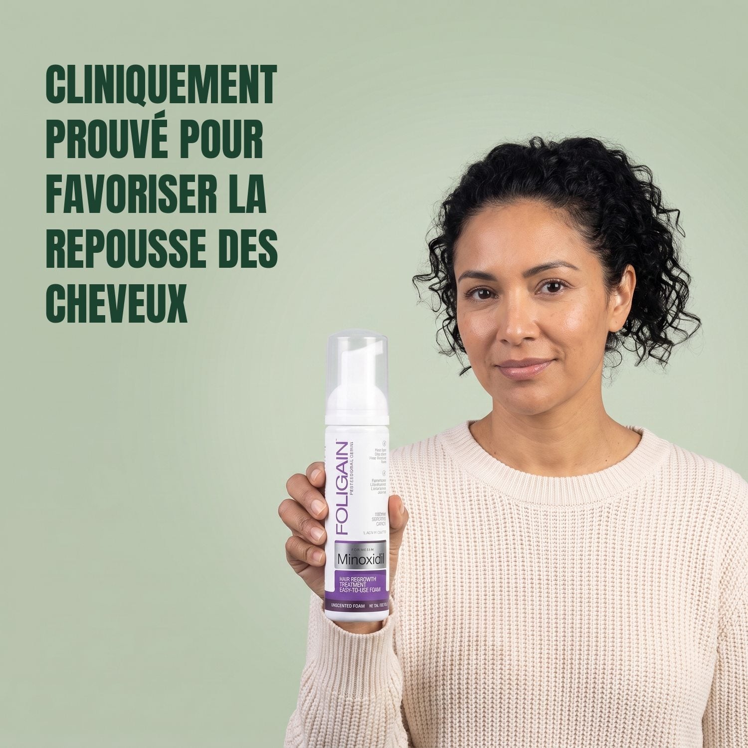 Woman holding the Foligain Minoxidil 2% foam can for women against a green background