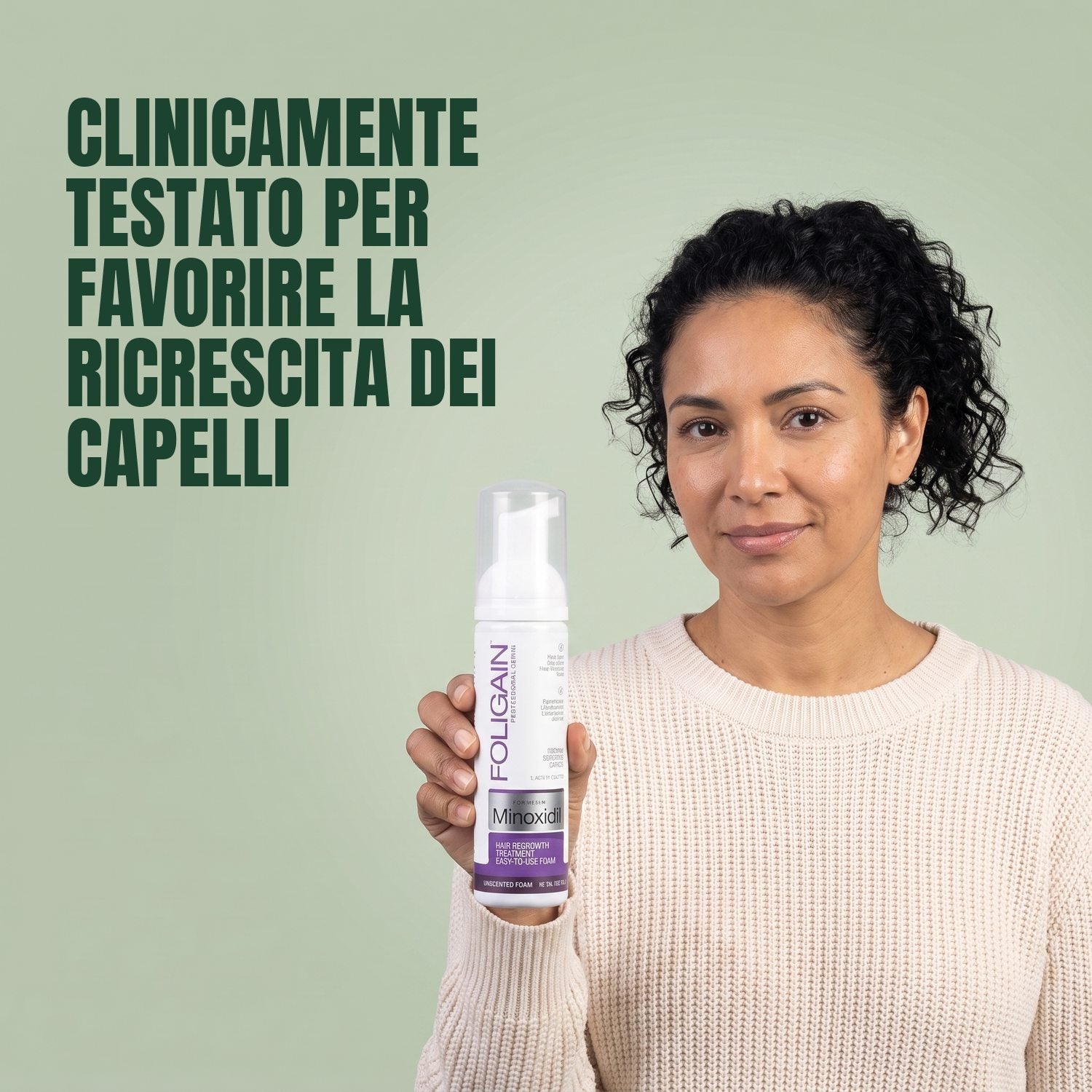 Woman holding the Foligain Minoxidil 2% foam can for women against a green background