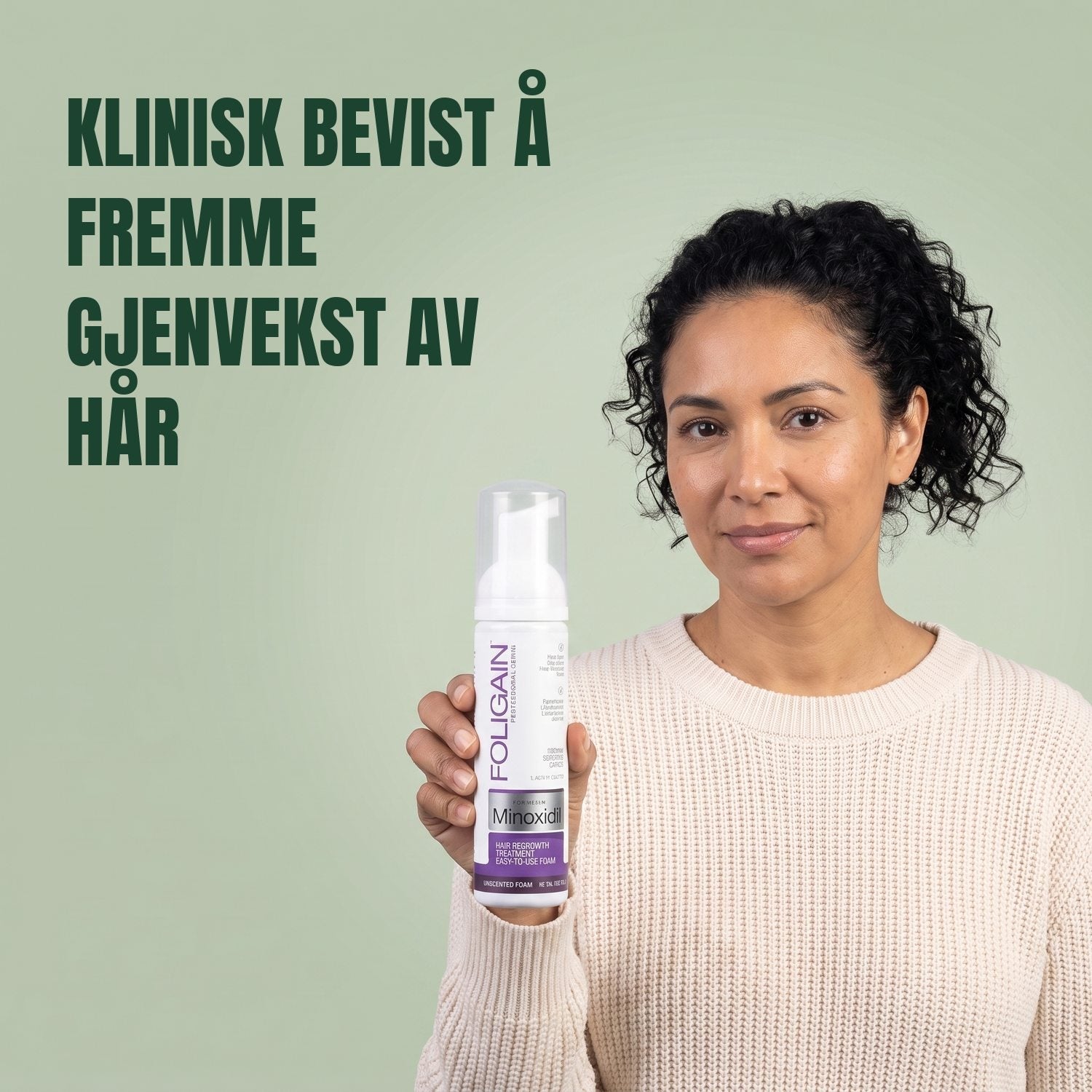 Woman holding the Foligain Minoxidil 2% foam can for women against a green background