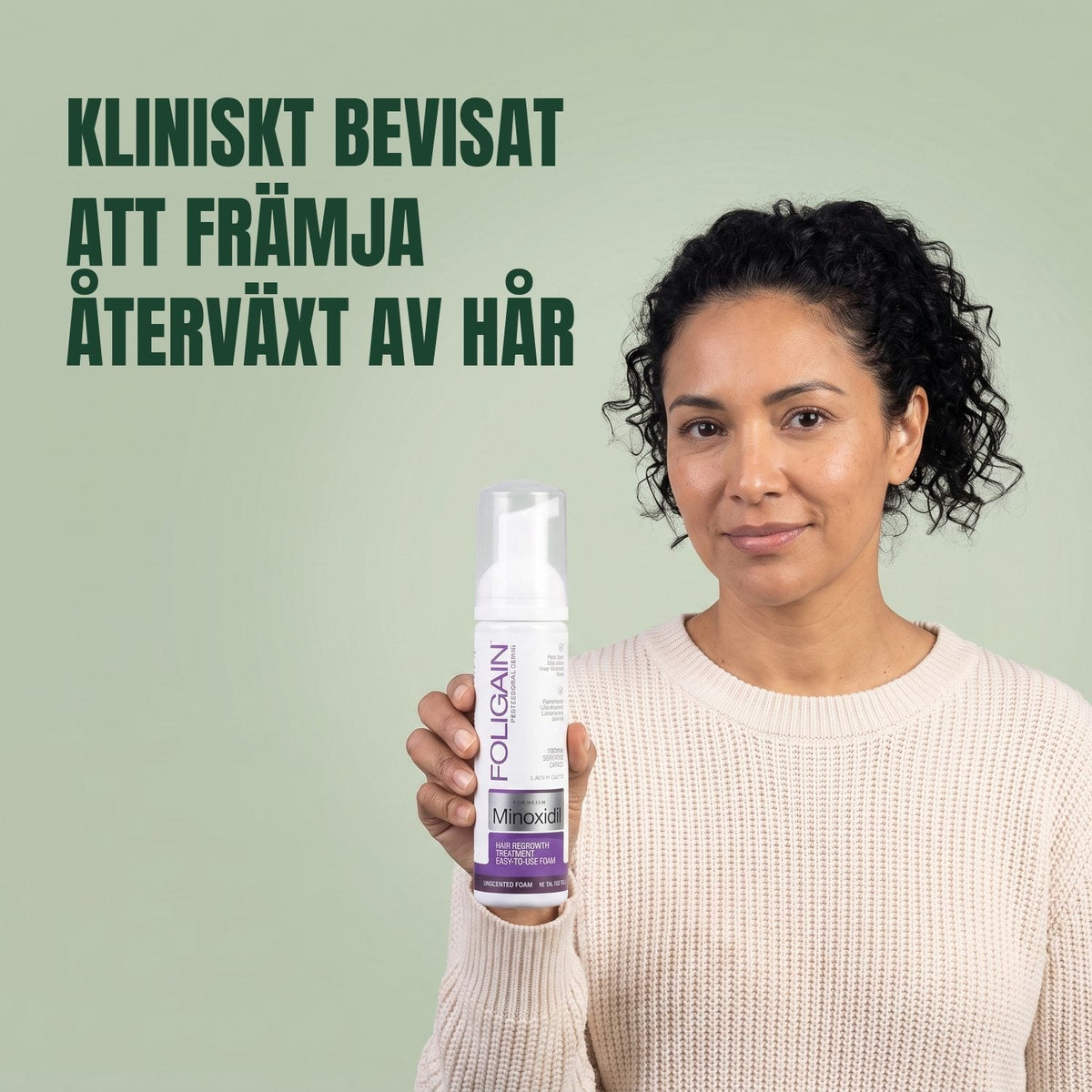 Woman holding the Foligain Minoxidil 2% foam can for women against a green background