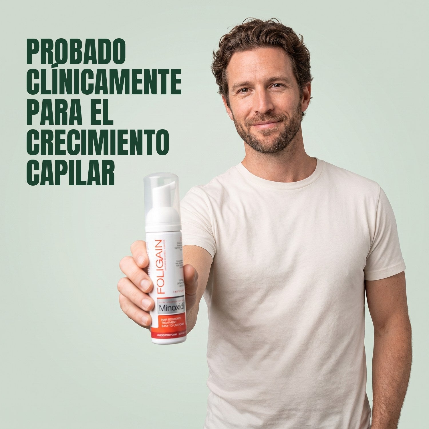 Man holding Foligain Minoxidil 5% foam for men against a green background