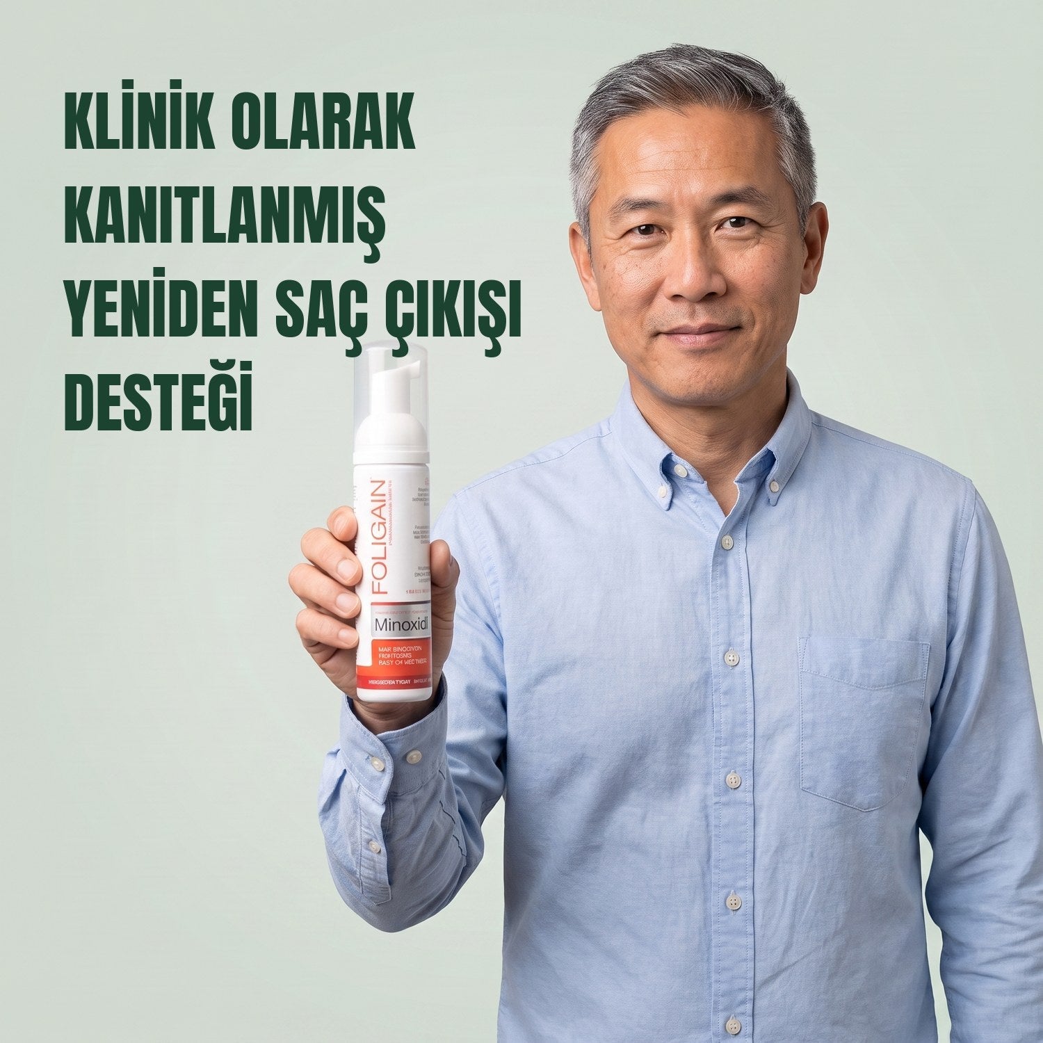 Man holding the Foligain Minoxidil 5% foam can for men against a green background