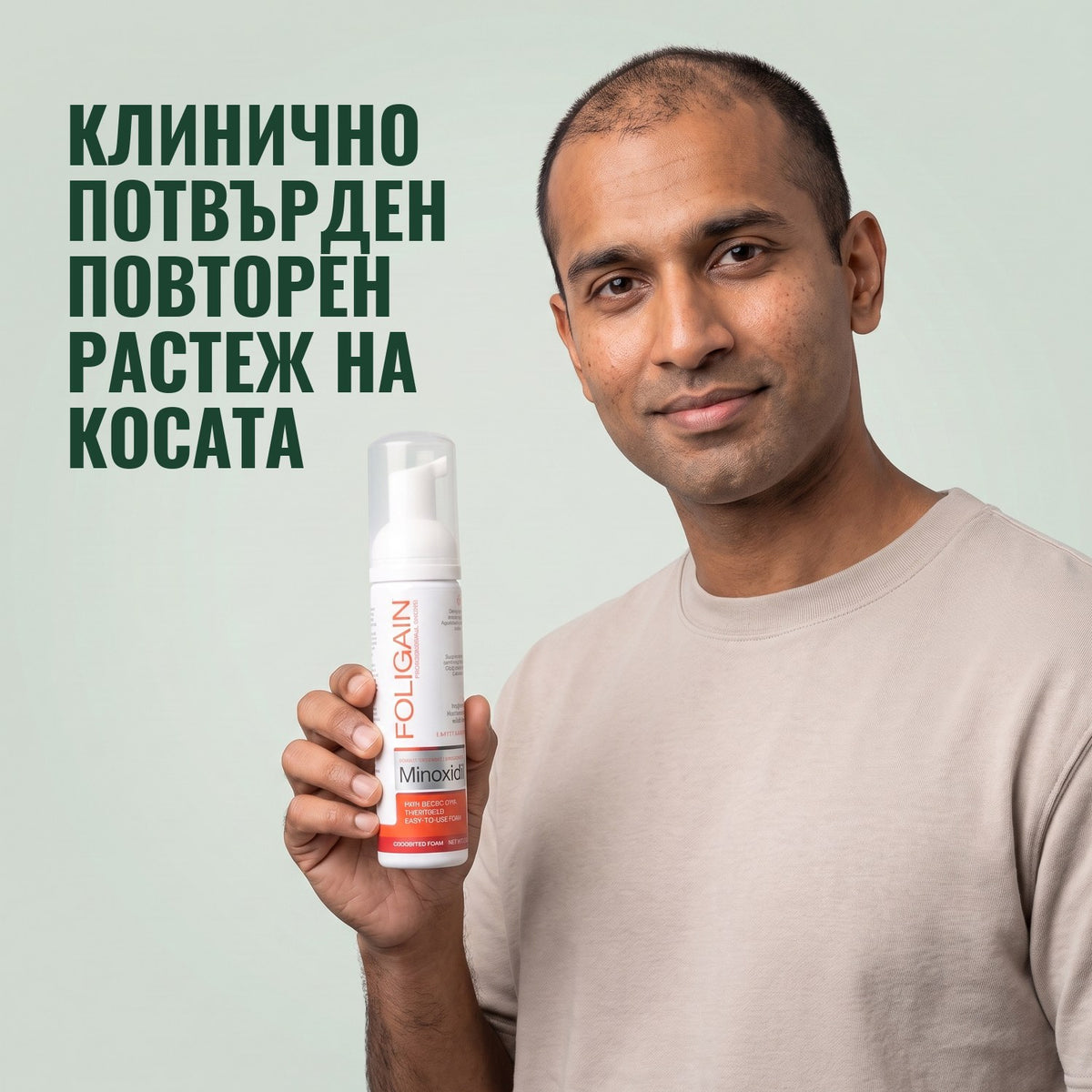 Мъж държи флакон Foligain миноксидил 5% пяна за мъже на зелен фон