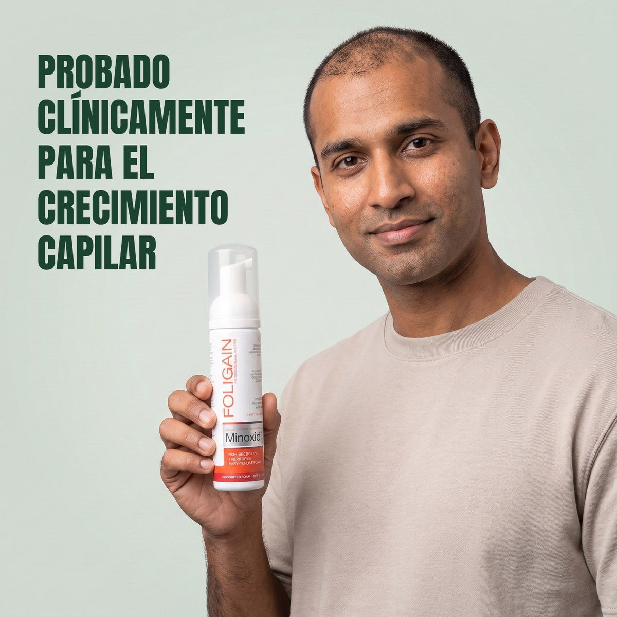 Man holding the Foligain Minoxidil 5% foam can for men against a green background