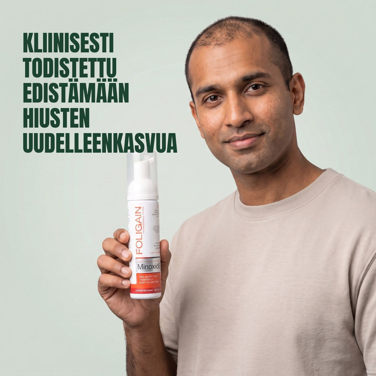 Man holding the Foligain Minoxidil 5% foam can for men against a green background