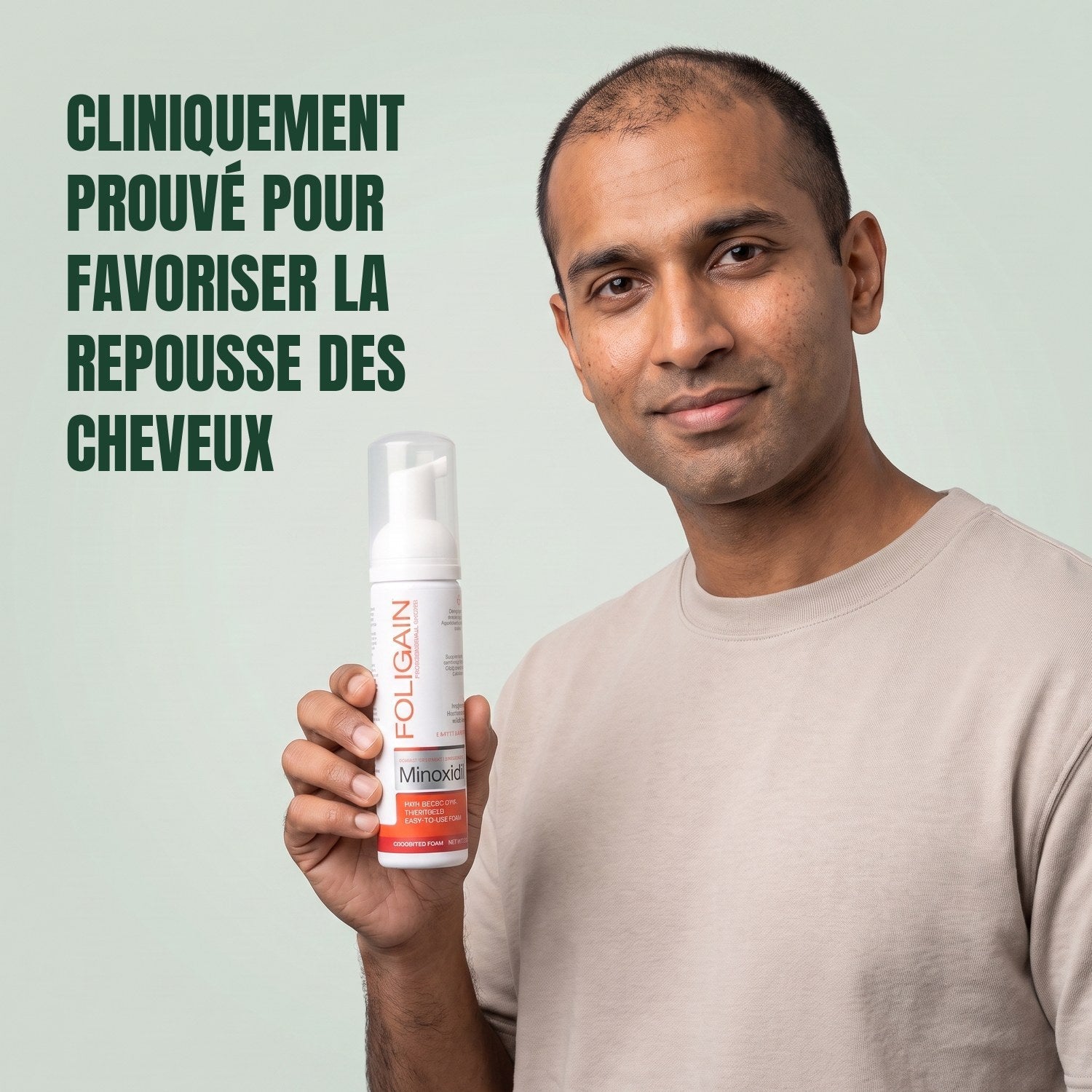 Man holding the Foligain Minoxidil 5% foam can for men against a green background