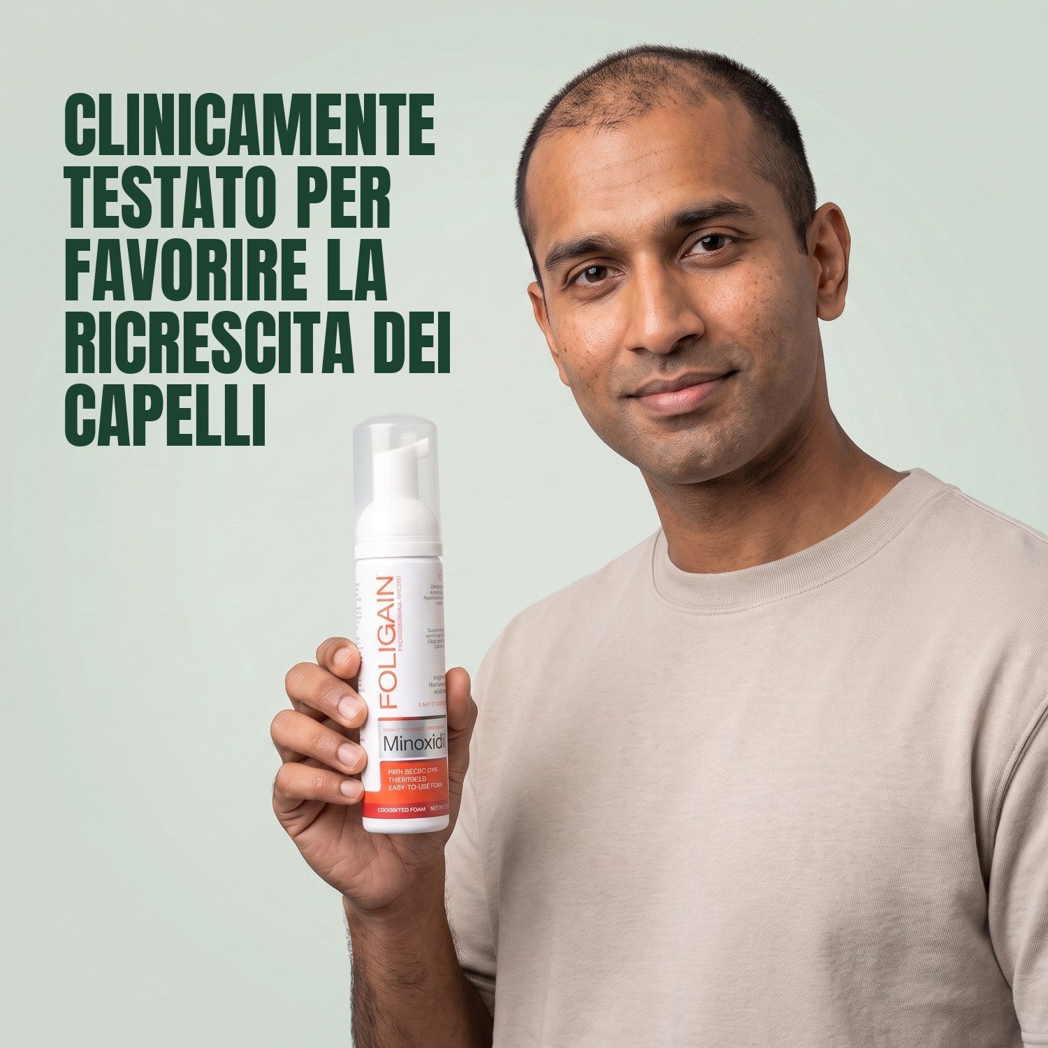 Man holding the Foligain Minoxidil 5% foam can for men against a green background