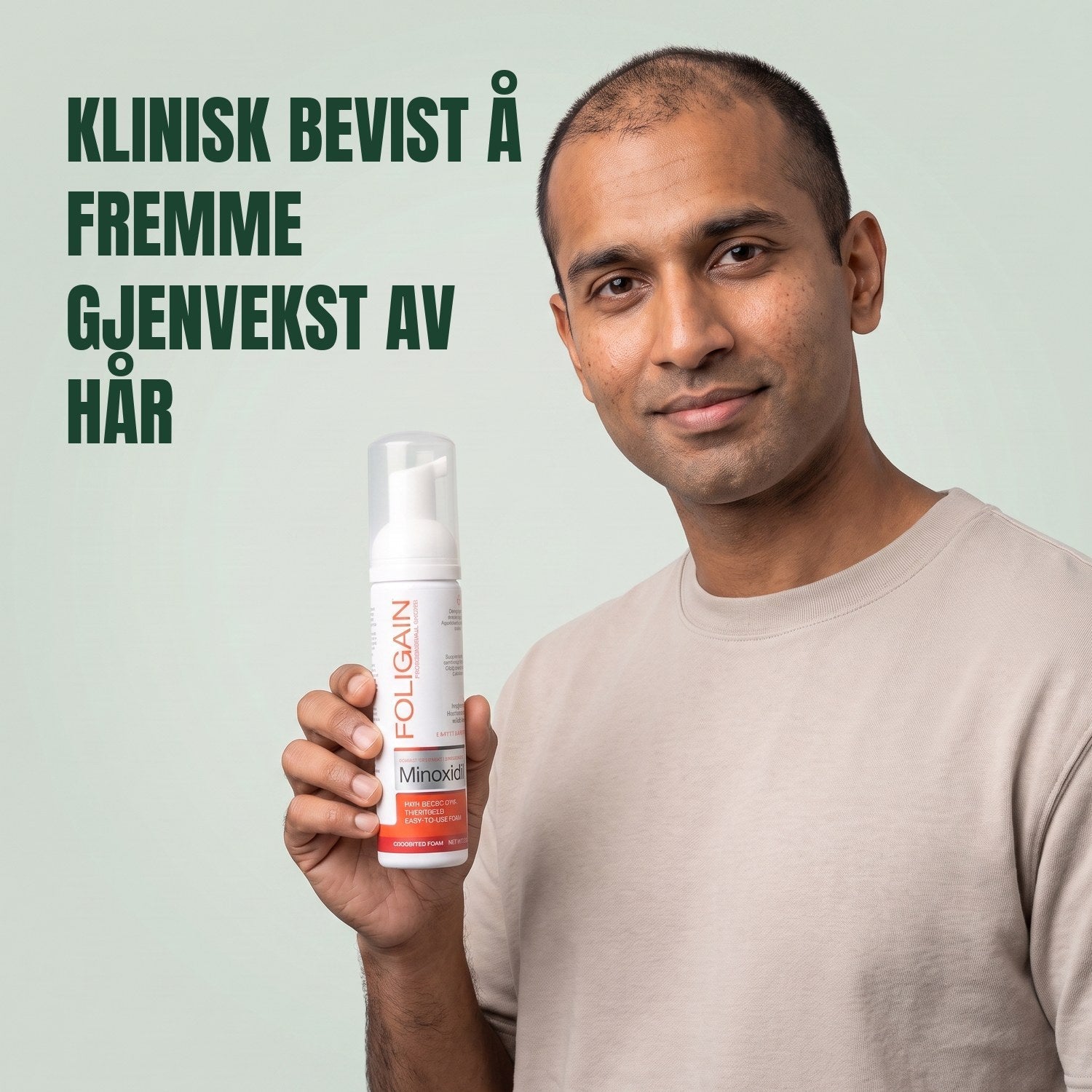 Man holding the Foligain Minoxidil 5% foam can for men against a green background