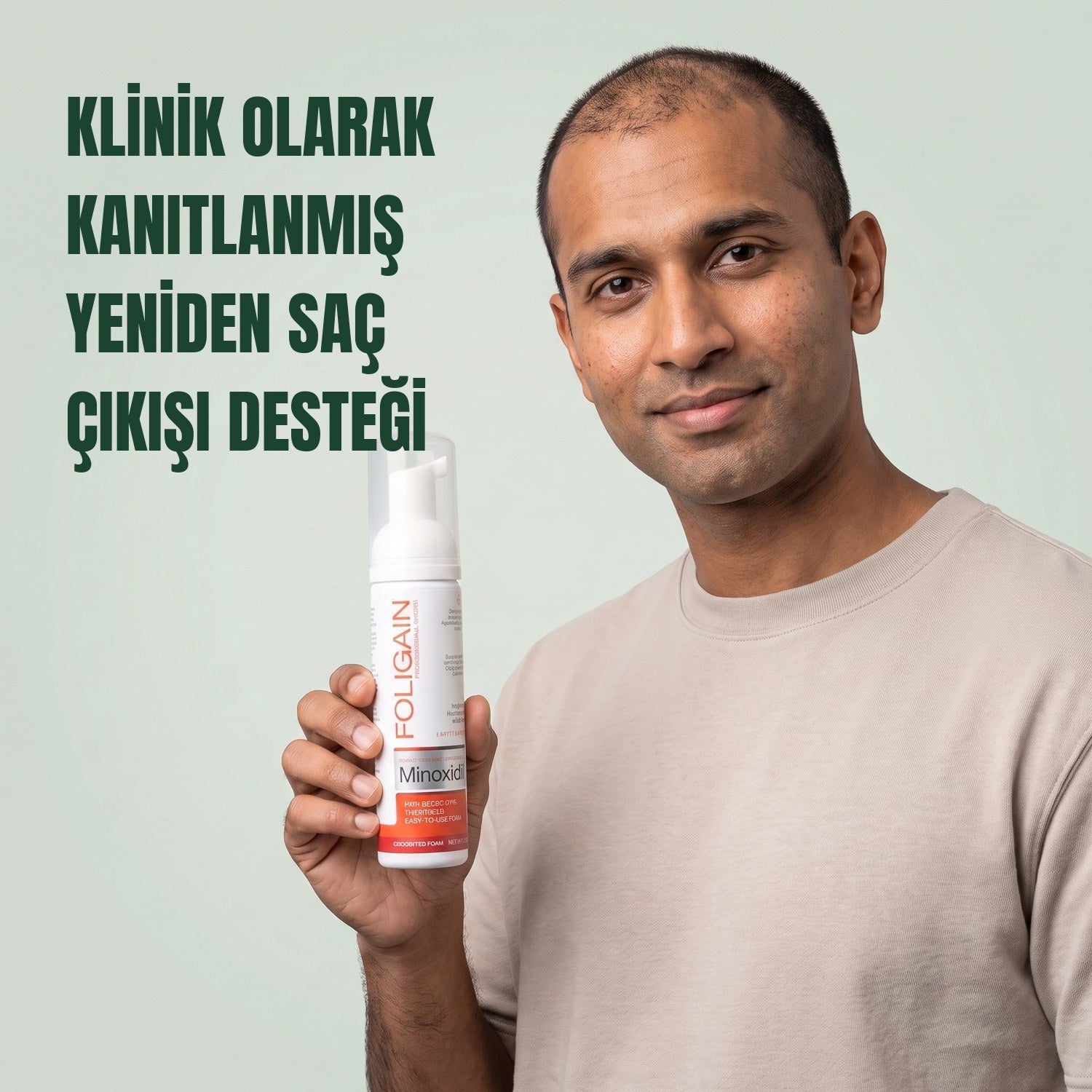 Man holding the Foligain Minoxidil 5% foam can for men against a green background