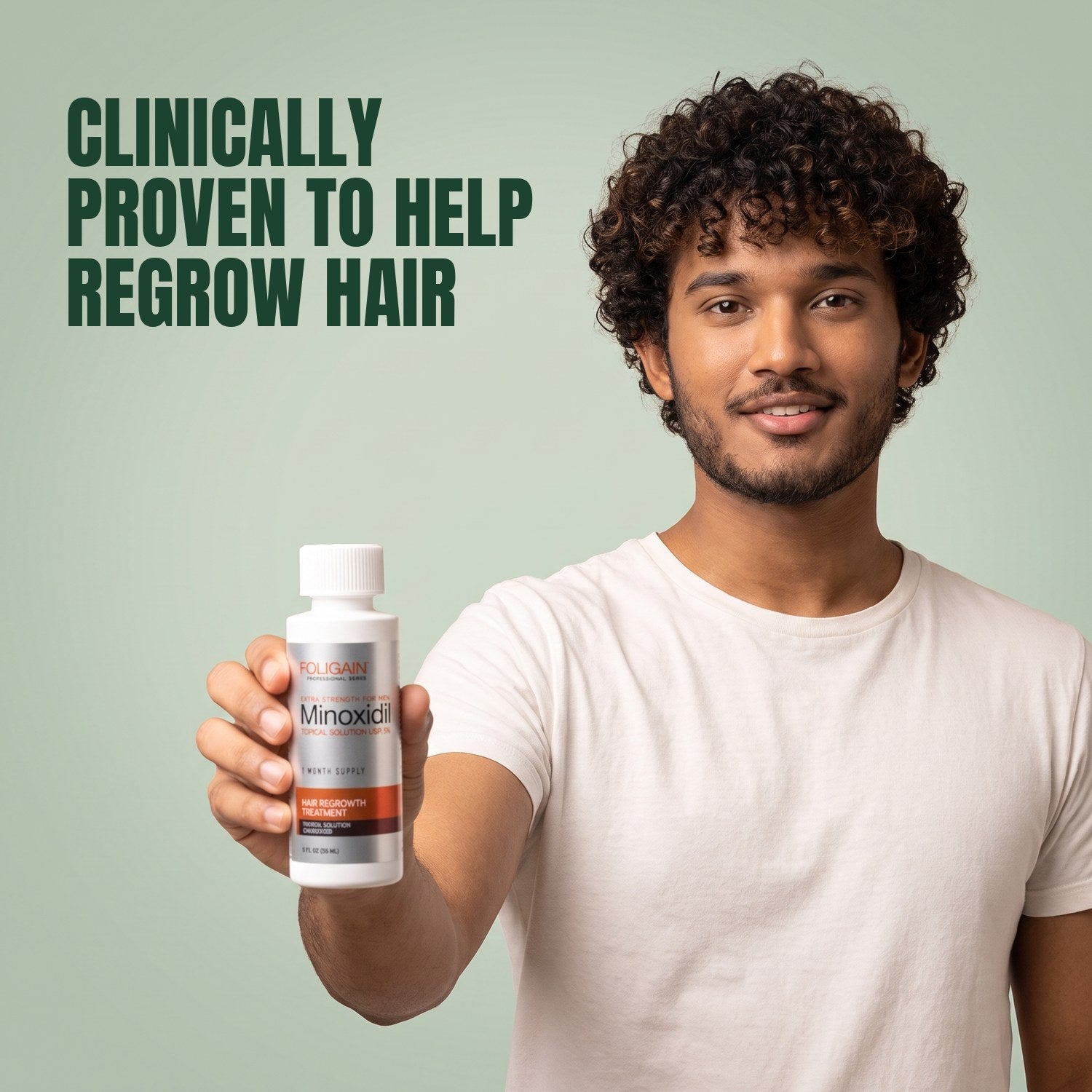Man holding a Foligain Minoxidil 5% lotion bottle for men against a green background