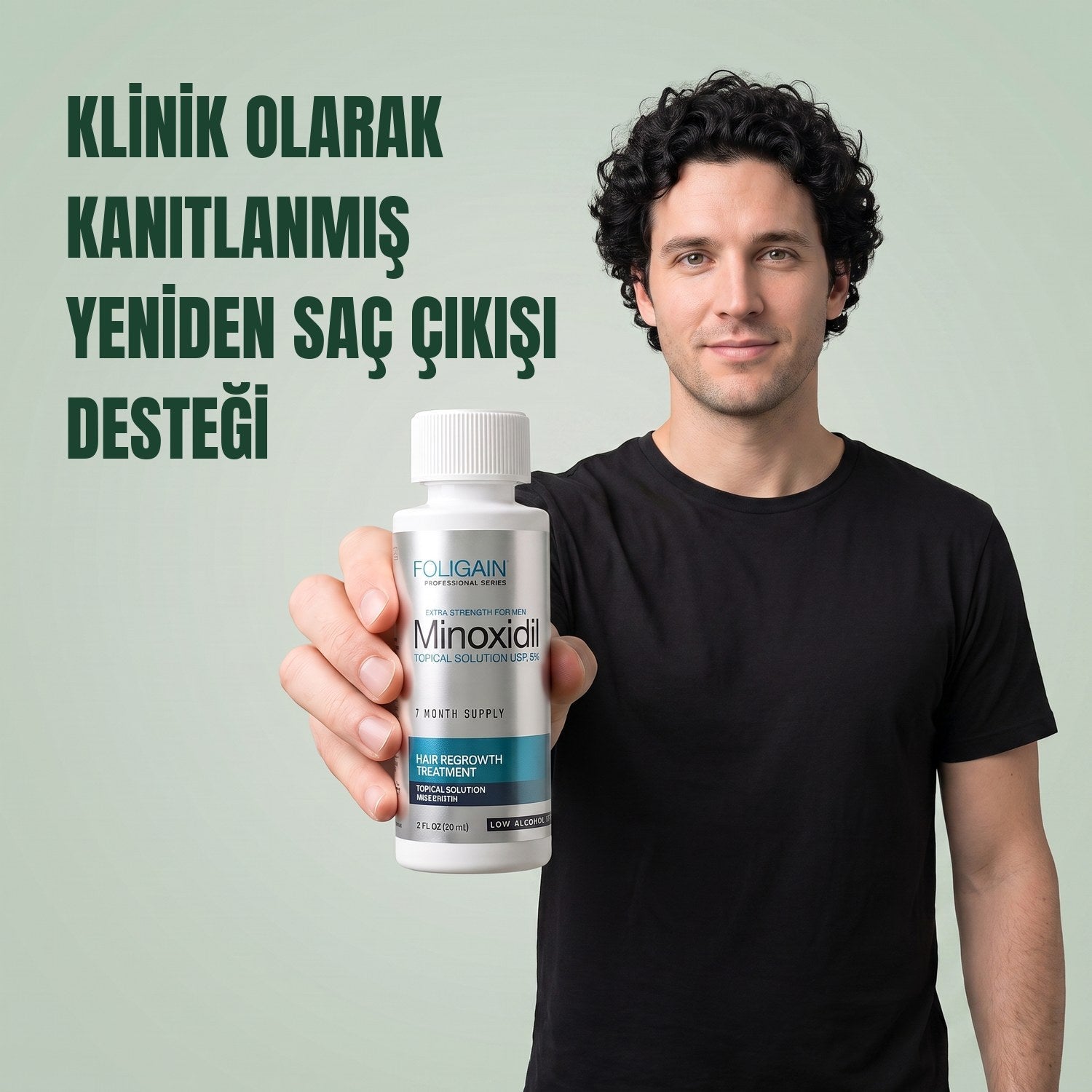 Man holding the Foligain Minoxidil 5% sensitive skin lotion bottle for men against a green background