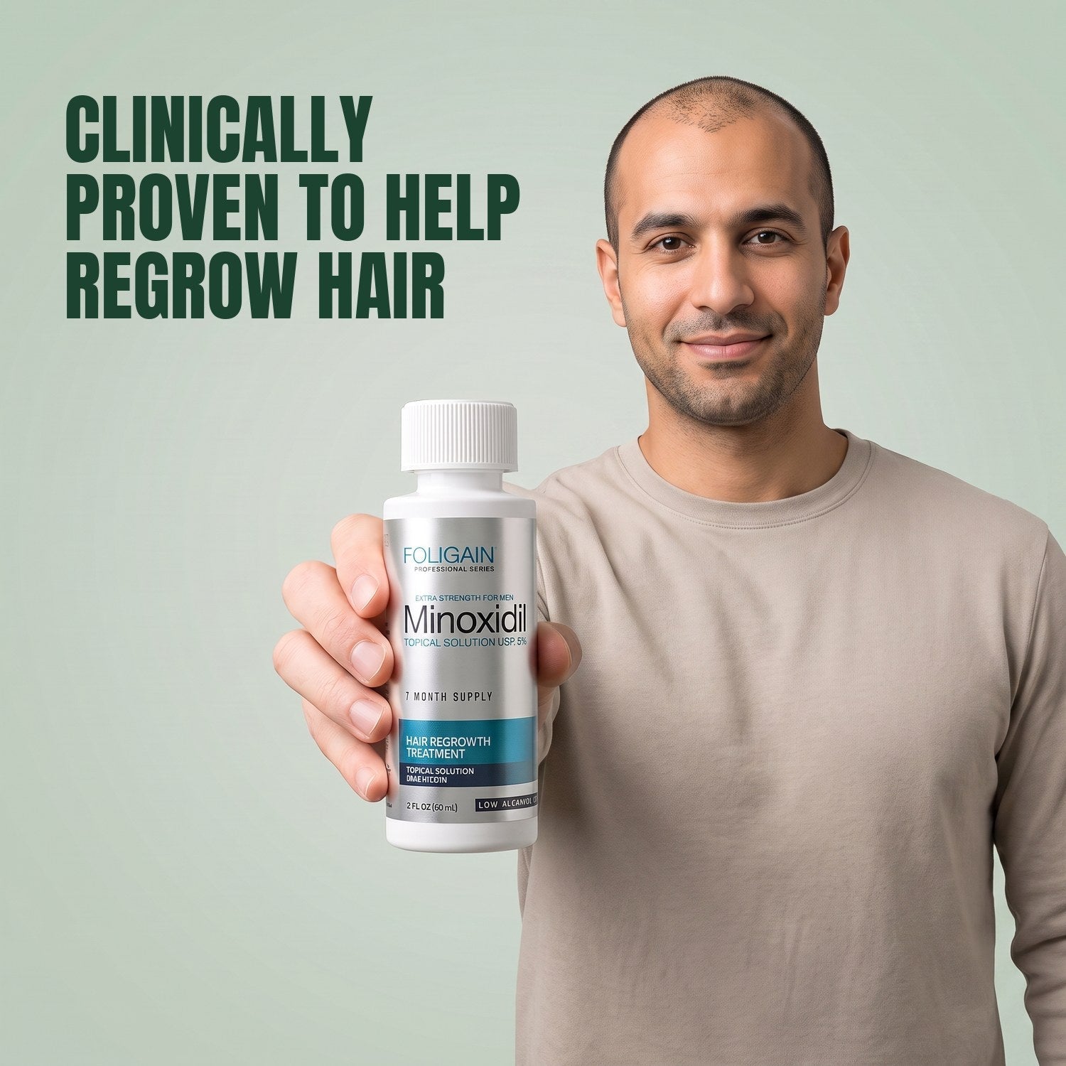 Man holding the Foligain Minoxidil 5% sensitive skin lotion bottle for men against a green background