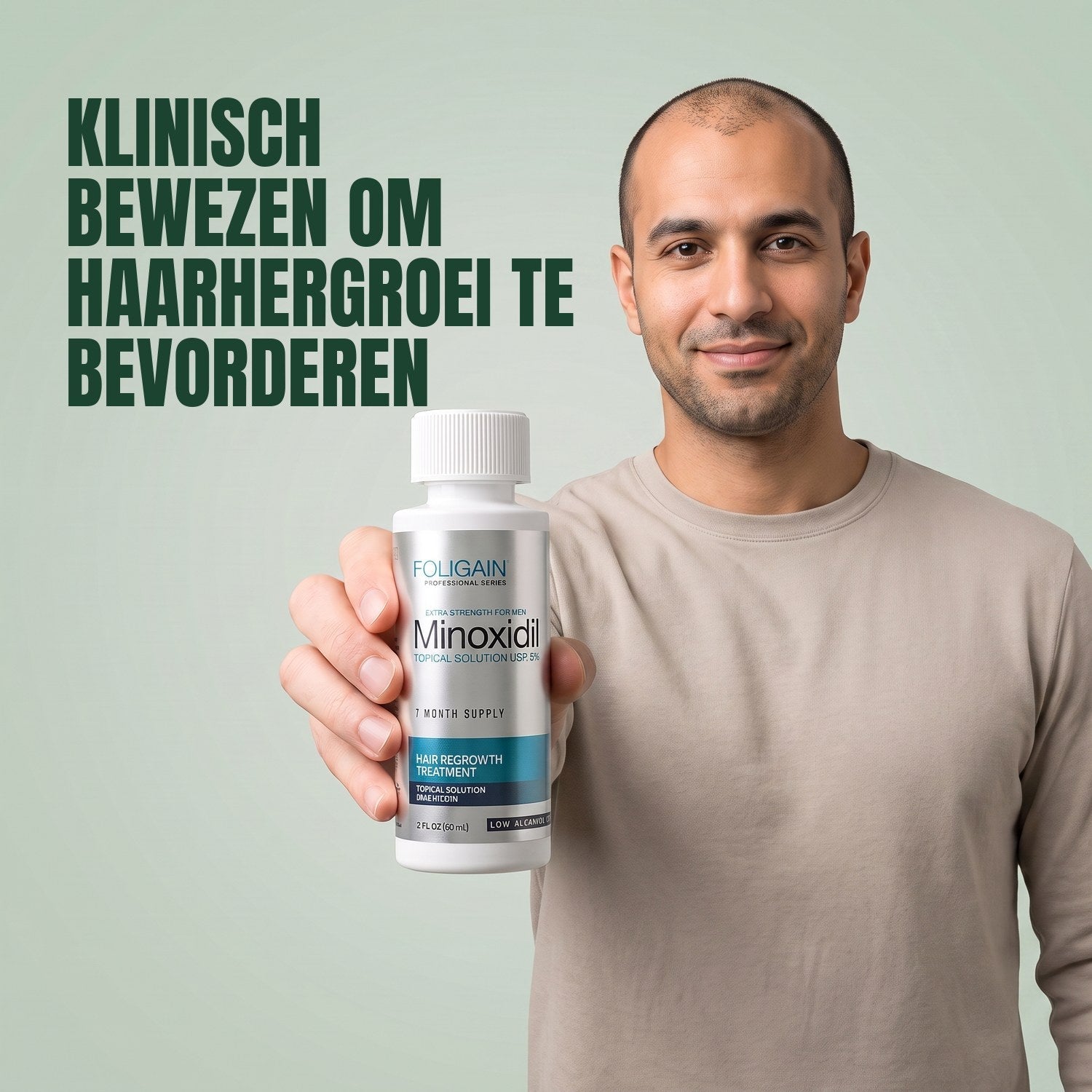 Man holding the Foligain Minoxidil 5% sensitive skin lotion bottle for men against a green background