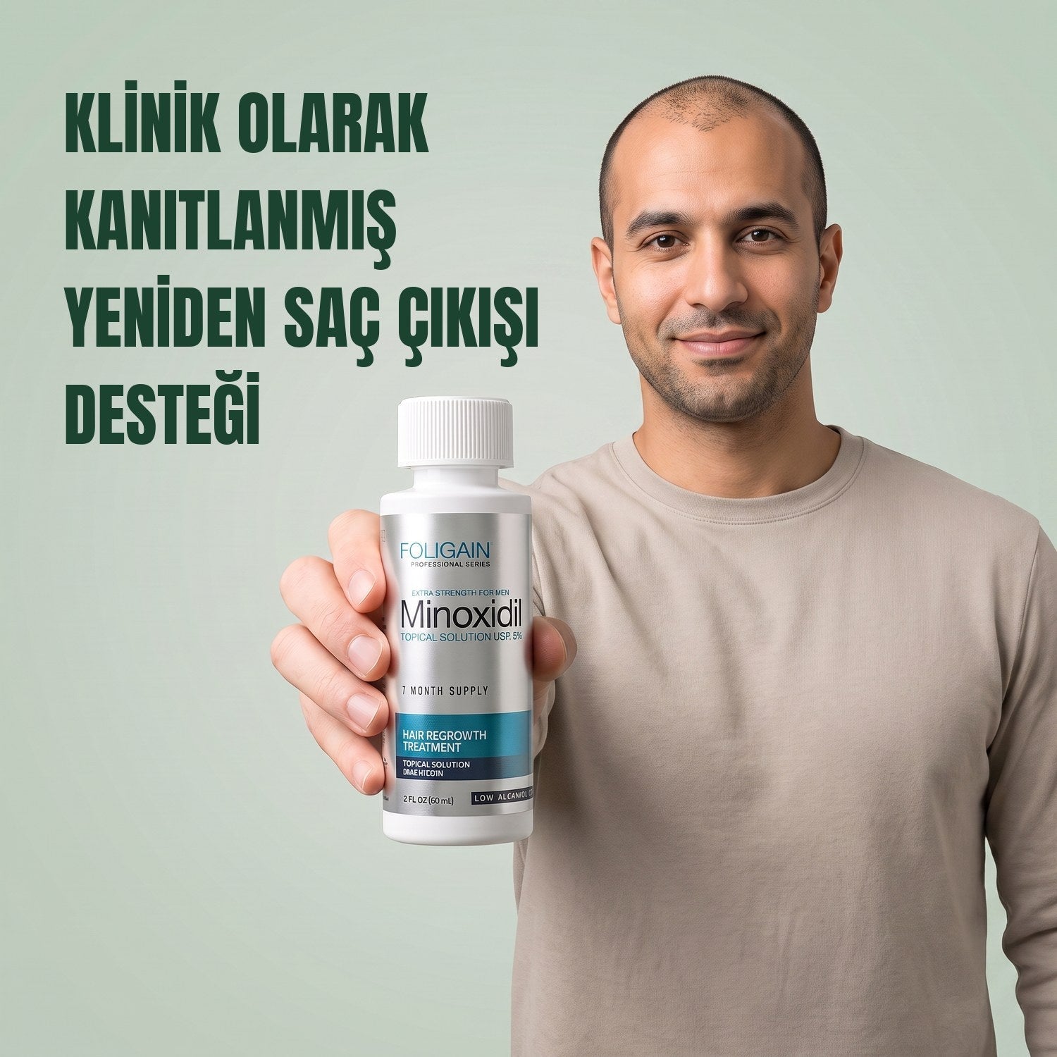 Man holding the Foligain Minoxidil 5% sensitive skin lotion bottle for men against a green background
