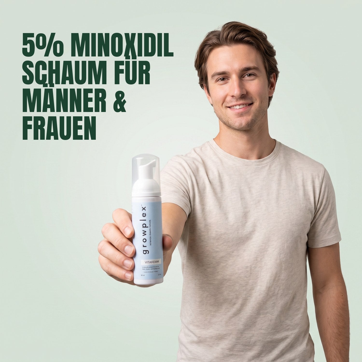 Man holding a Growplex VitaFoam minoxidil 5% foam bottle against a green background