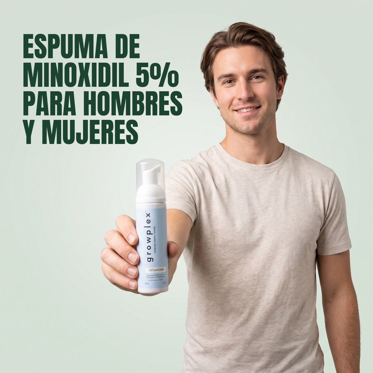 Man holding a Growplex VitaFoam minoxidil 5% foam bottle against a green background