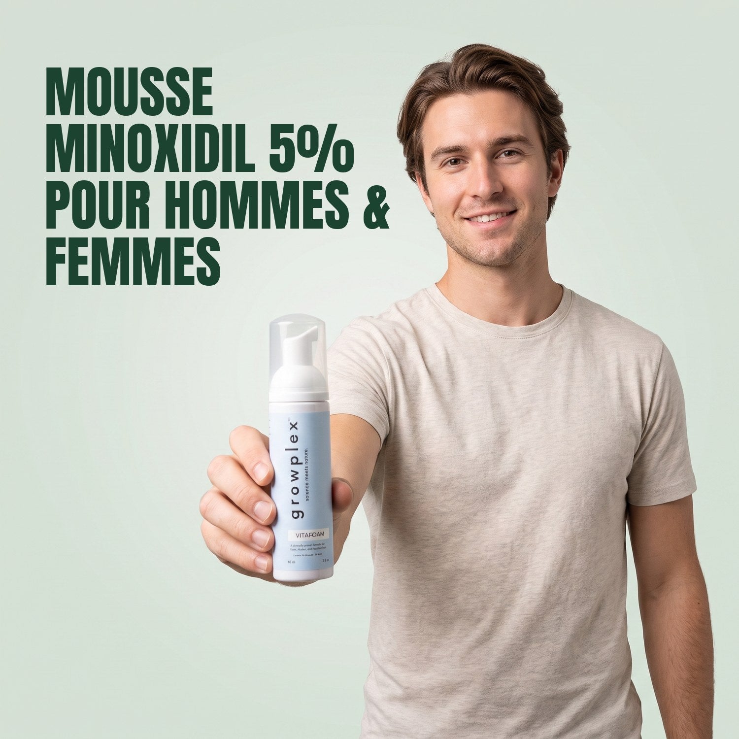 Man holding a Growplex VitaFoam minoxidil 5% foam bottle against a green background