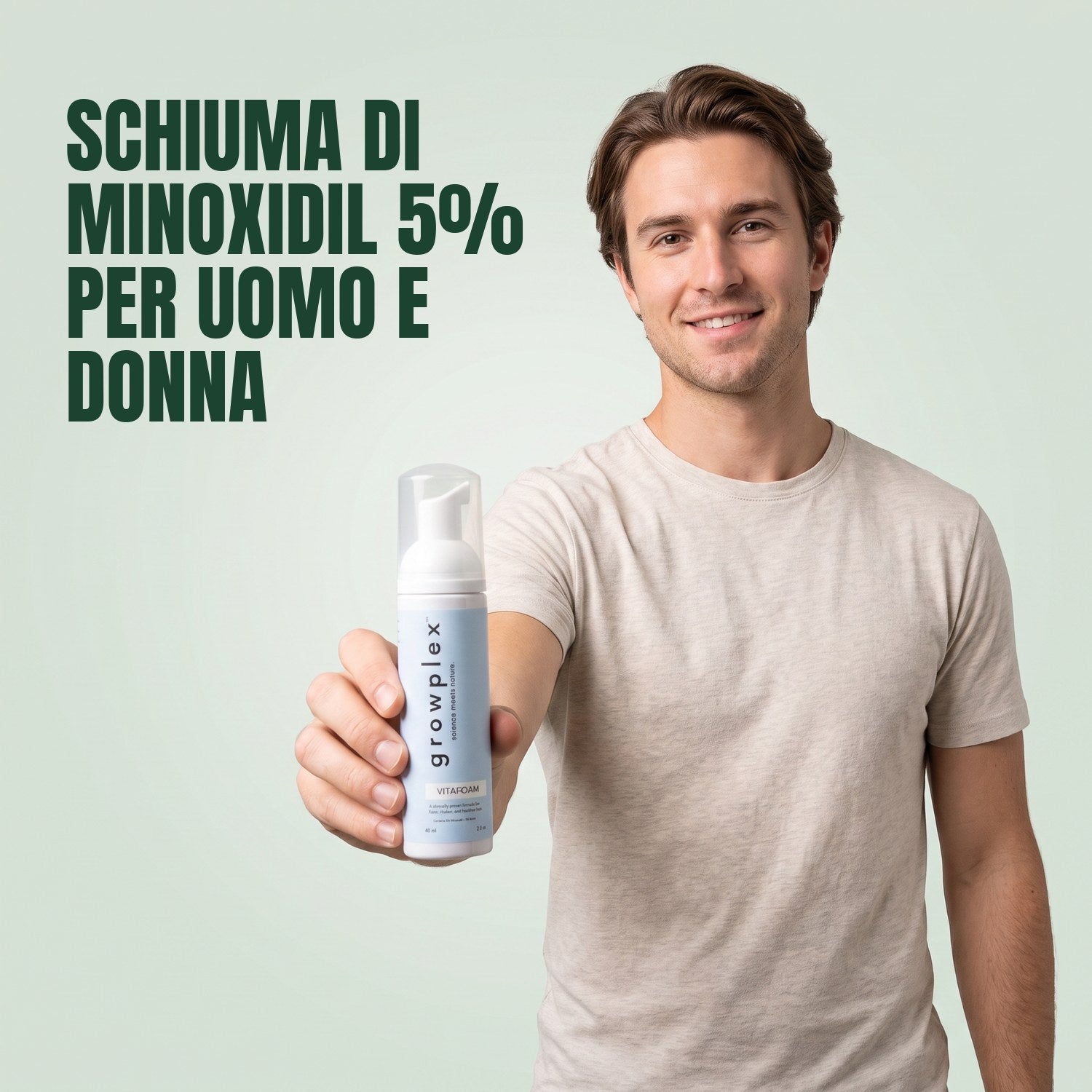 Man holding a Growplex VitaFoam minoxidil 5% foam bottle against a green background