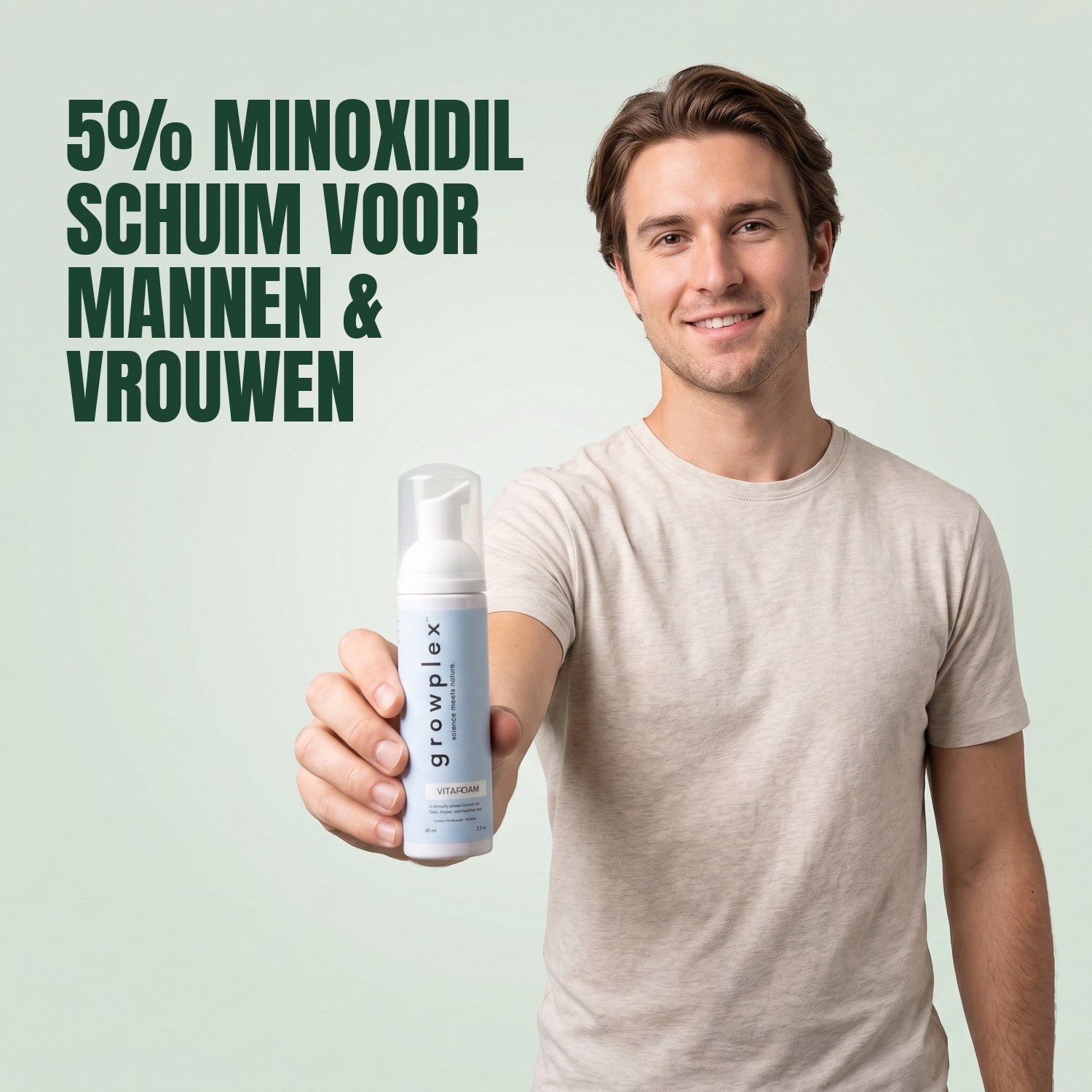 Man holding a Growplex VitaFoam minoxidil 5% foam bottle against a green background