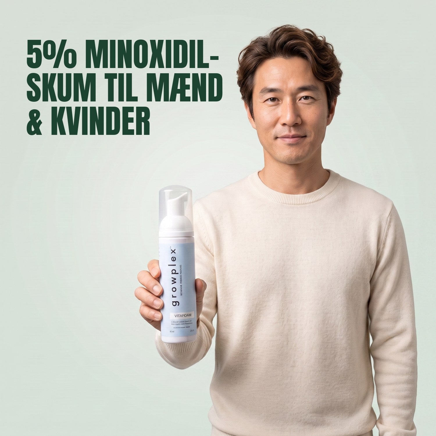 Man holding the Growplex VitaFoam minoxidil 5% foam bottle against a green background