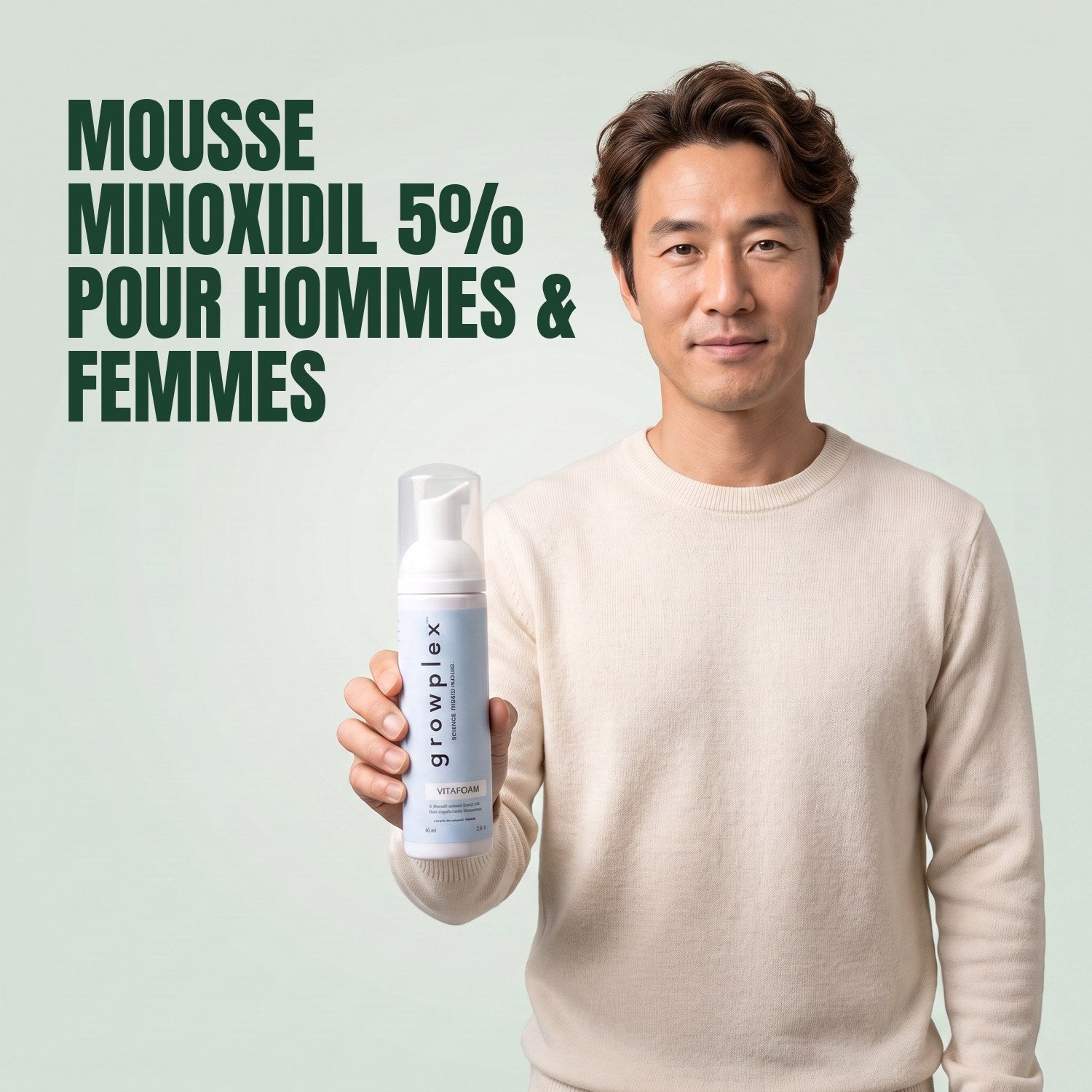 Man holding the Growplex VitaFoam minoxidil 5% foam bottle against a green background