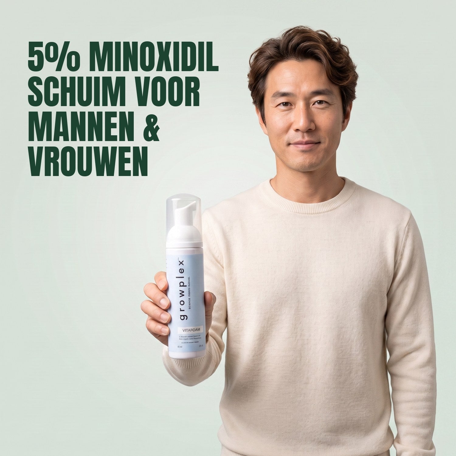 Man holding the Growplex VitaFoam minoxidil 5% foam bottle against a green background
