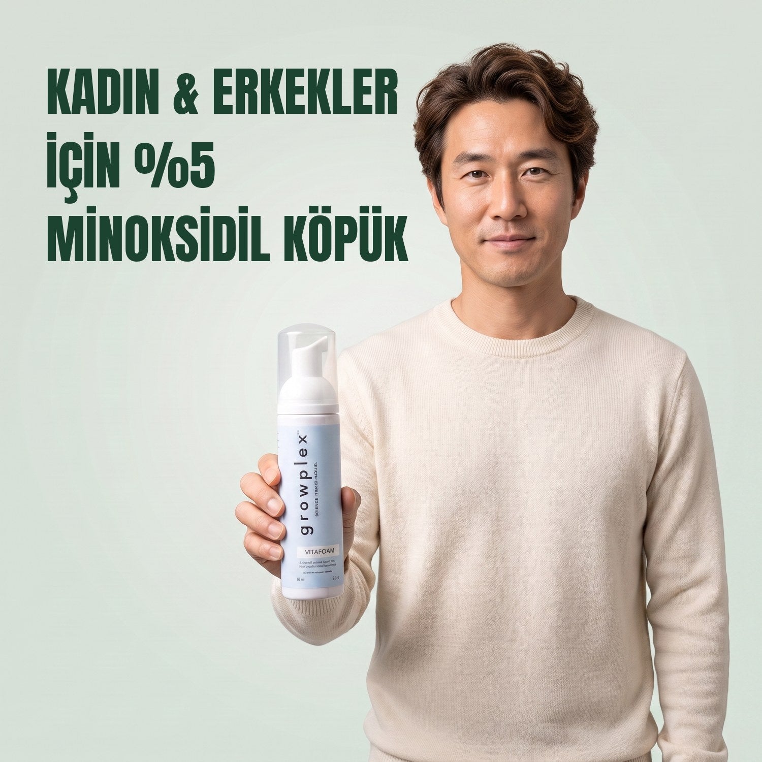 Man holding the Growplex VitaFoam minoxidil 5% foam bottle against a green background
