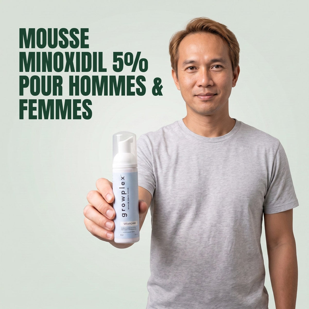 Man holding the Growplex VitaFoam minoxidil 5% foam bottle against a green background
