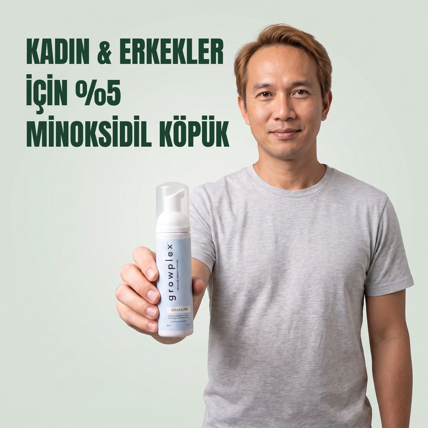Man holding the Growplex VitaFoam minoxidil 5% foam bottle against a green background