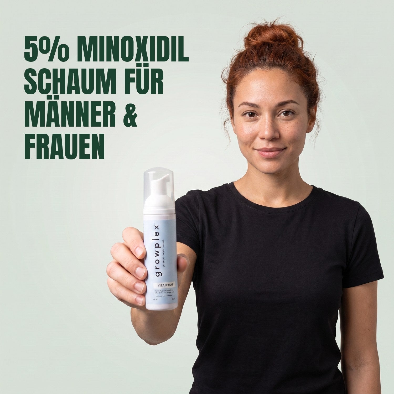 Woman holding the Growplex VitaFoam minoxidil 5% foam bottle against a green background