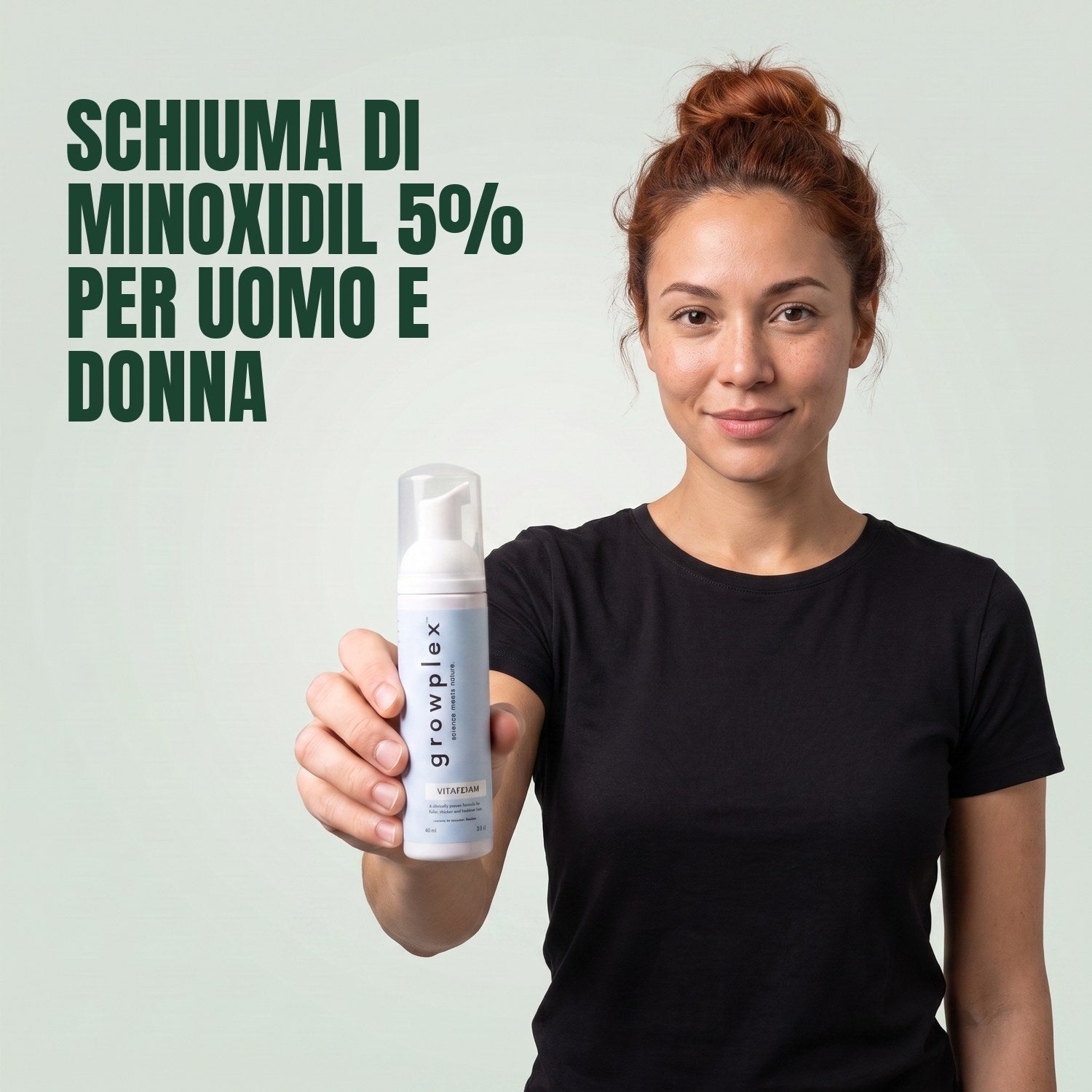 Woman holding the Growplex VitaFoam minoxidil 5% foam bottle against a green background
