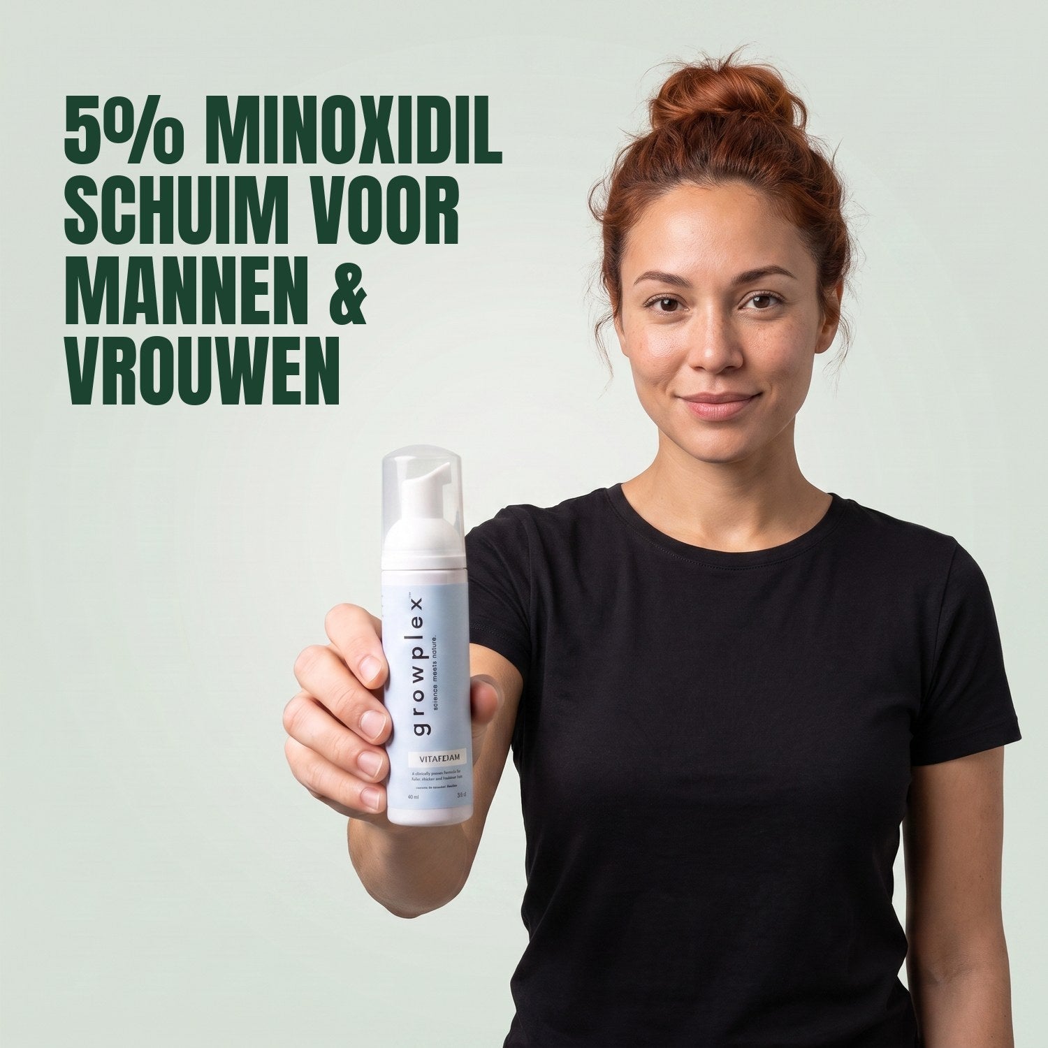 Woman holding the Growplex VitaFoam minoxidil 5% foam bottle against a green background