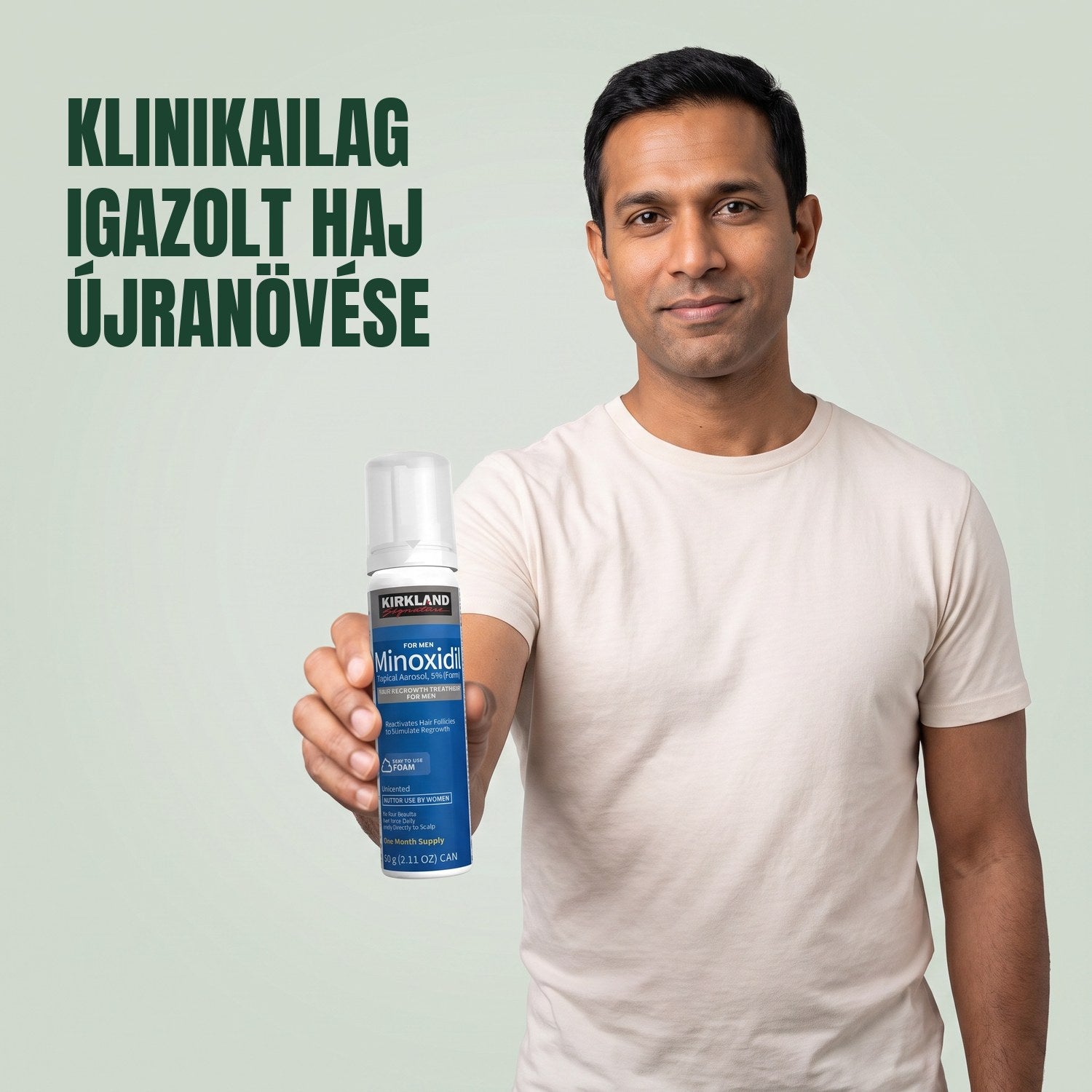 Férfi Kirkland Signature Minoxidil 5% habos dobozzal a kezében, zöld háttér előtt