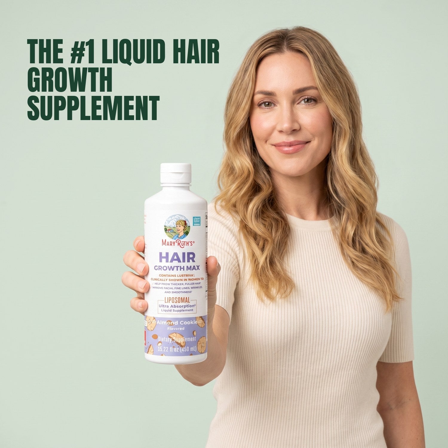 Woman holding a MaryRuth Organics Hair Growth Max Liposomal bottle against a green background