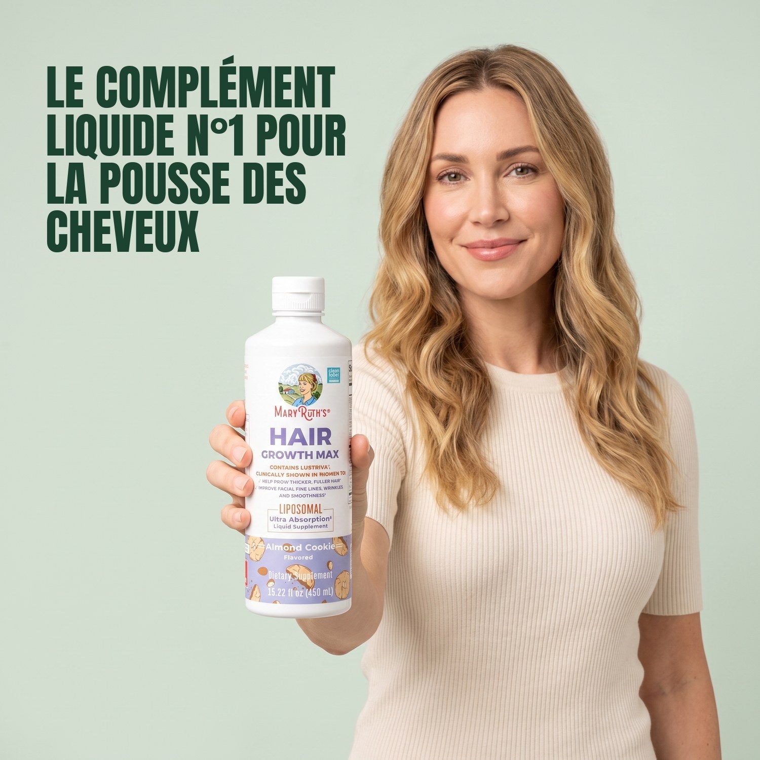 Woman holding a MaryRuth Organics Hair Growth Max Liposomal bottle against a green background
