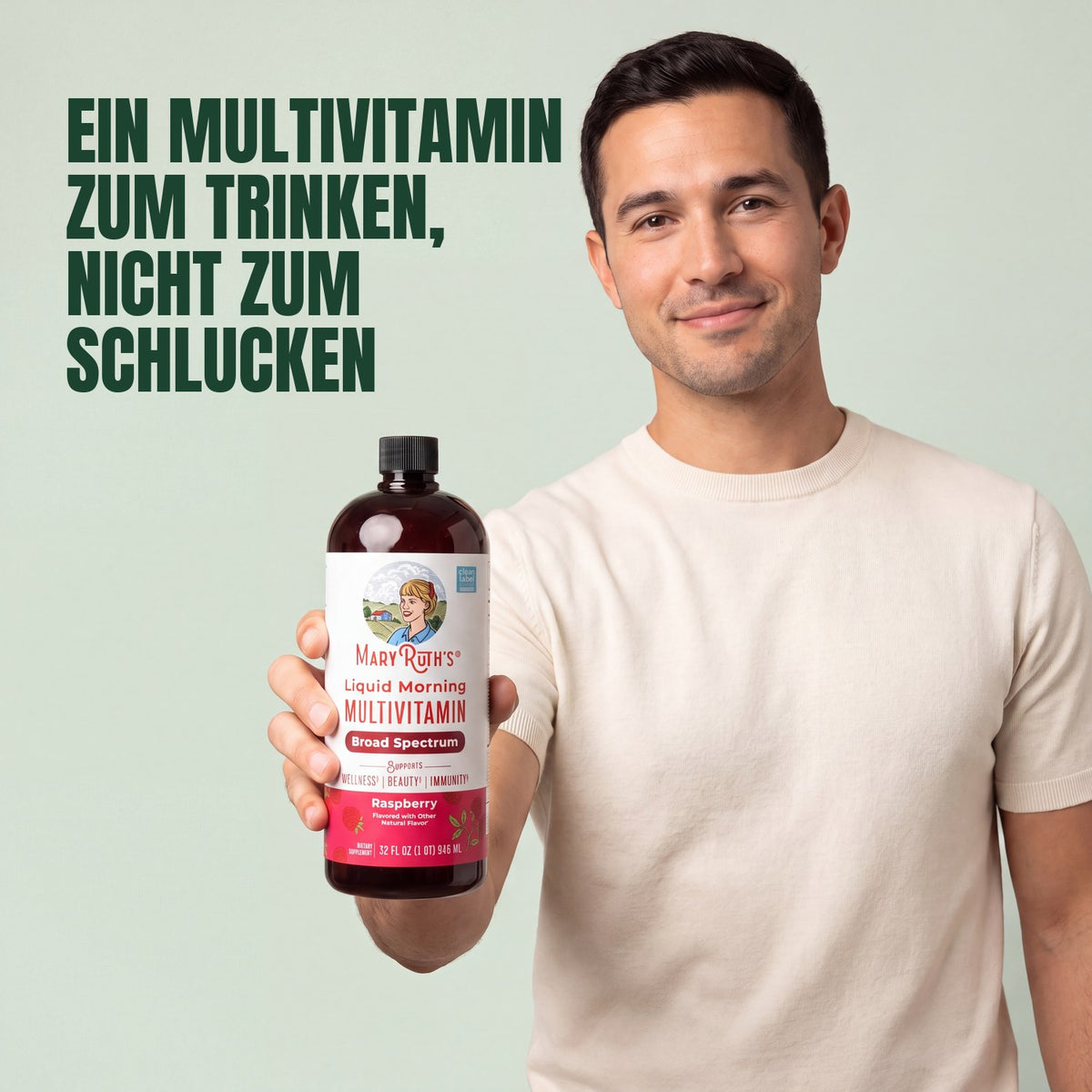 Man holding a MaryRuth Organics Liquid Morning Multivitamin raspberry bottle against a green background